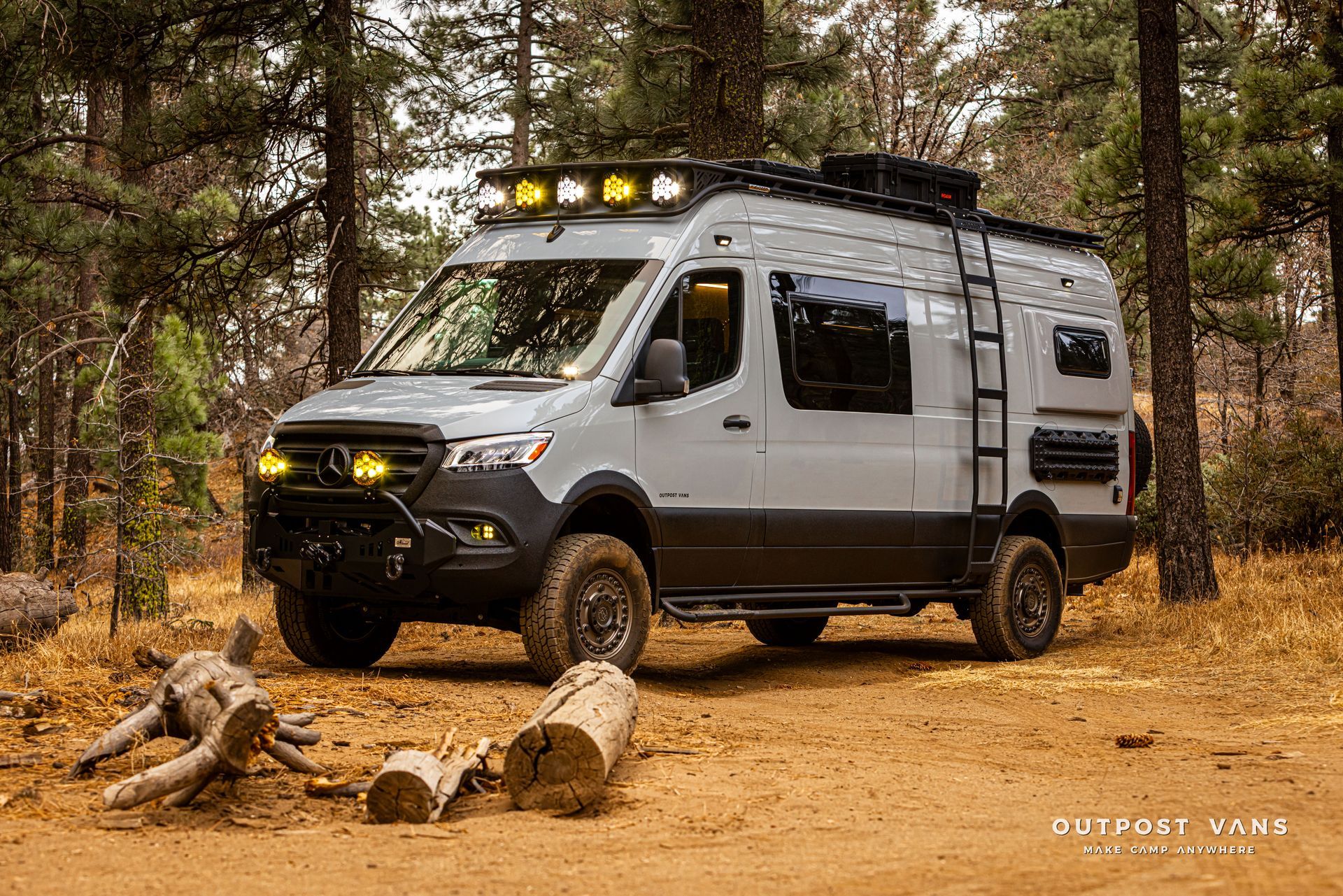 A camper van is parked in the middle of a forest.