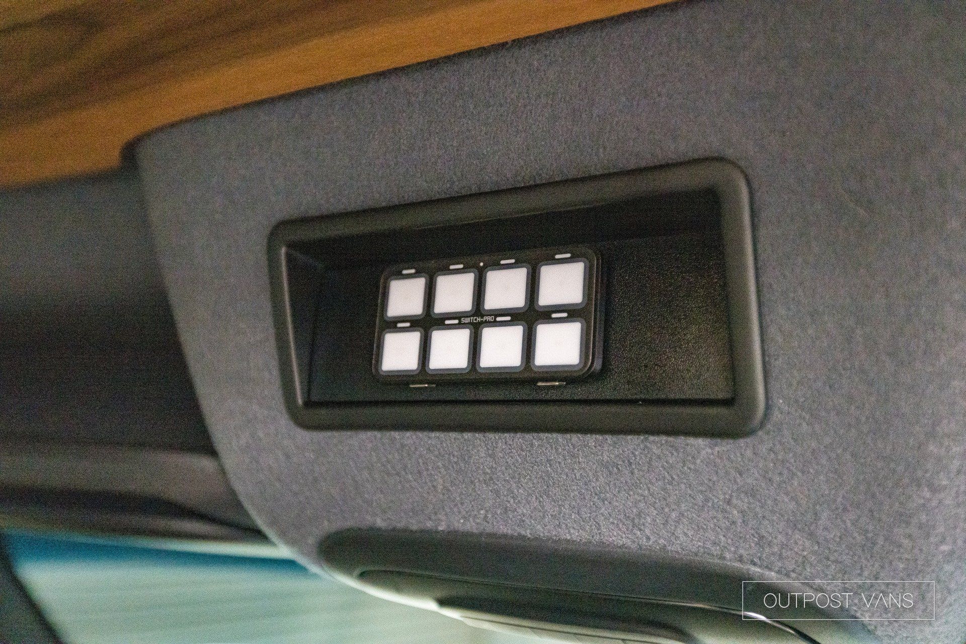 A close up of a switch on the ceiling of a car.