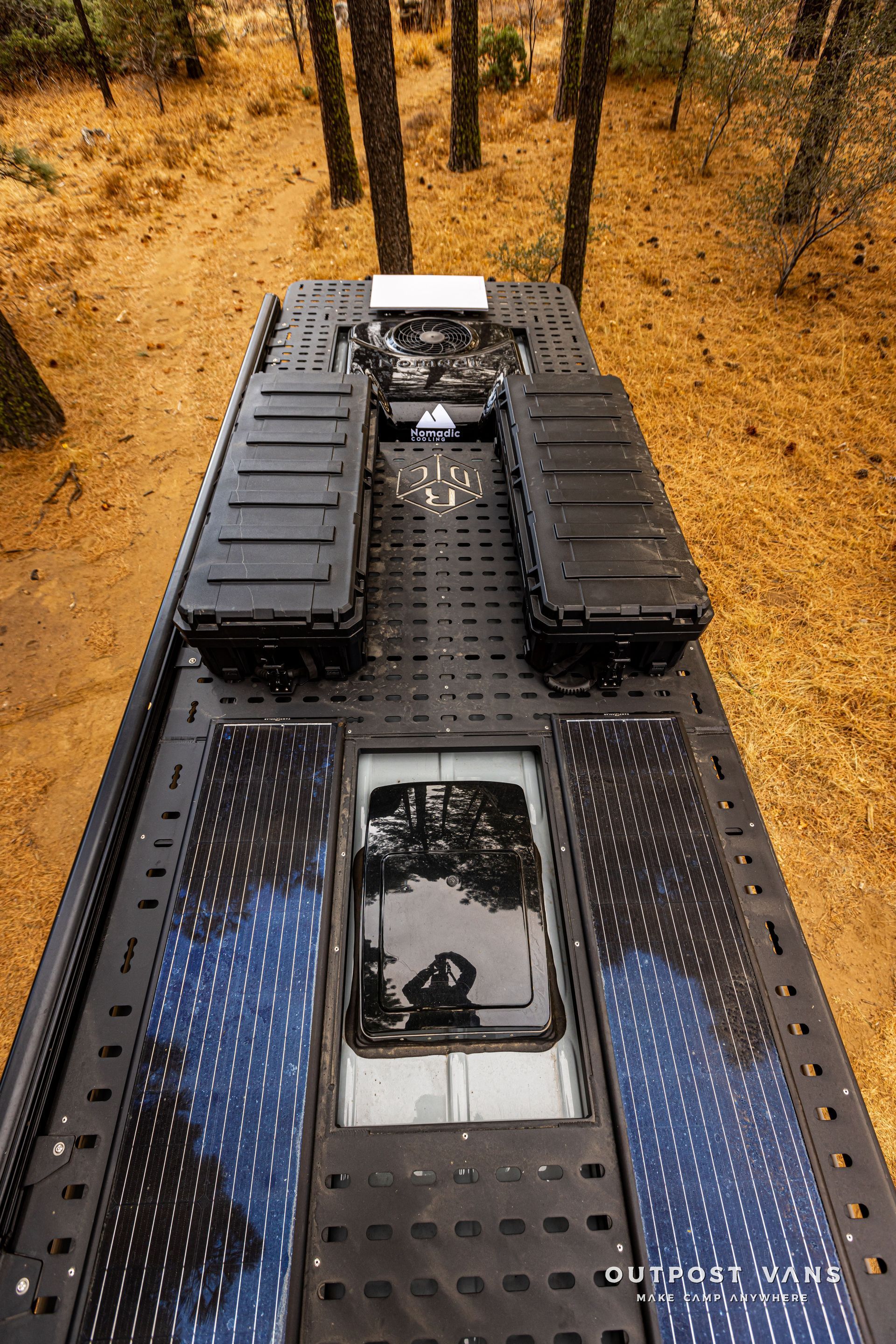 The roof of a truck is sitting in the middle of a forest.