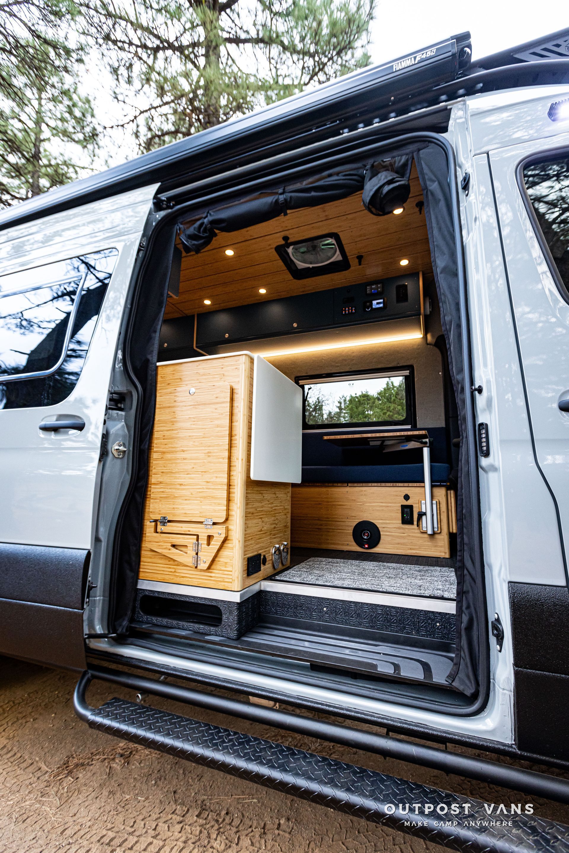 The door of a van is open and shows the inside of the van.