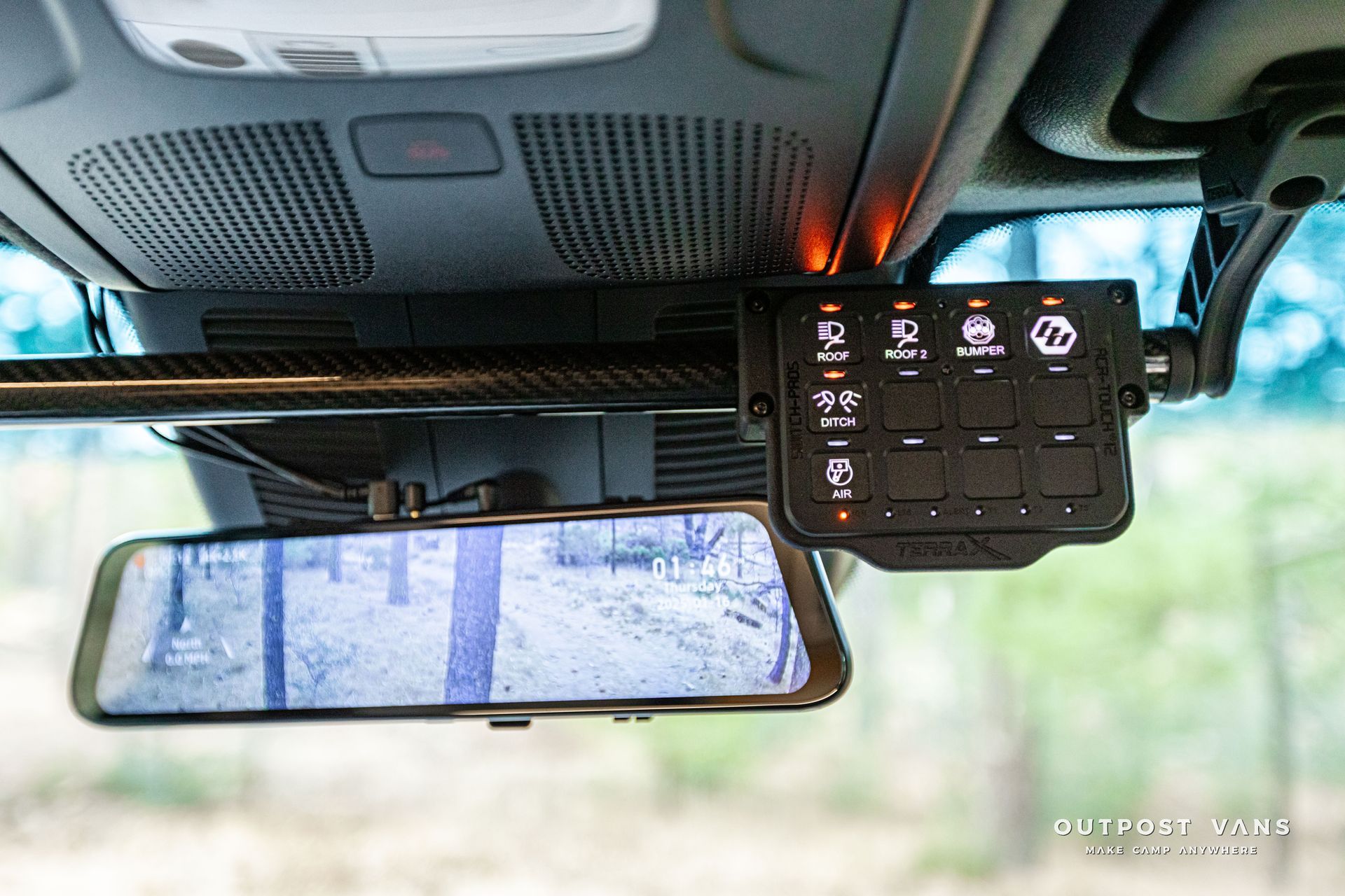 A rear view mirror with a camera attached to it in a car.