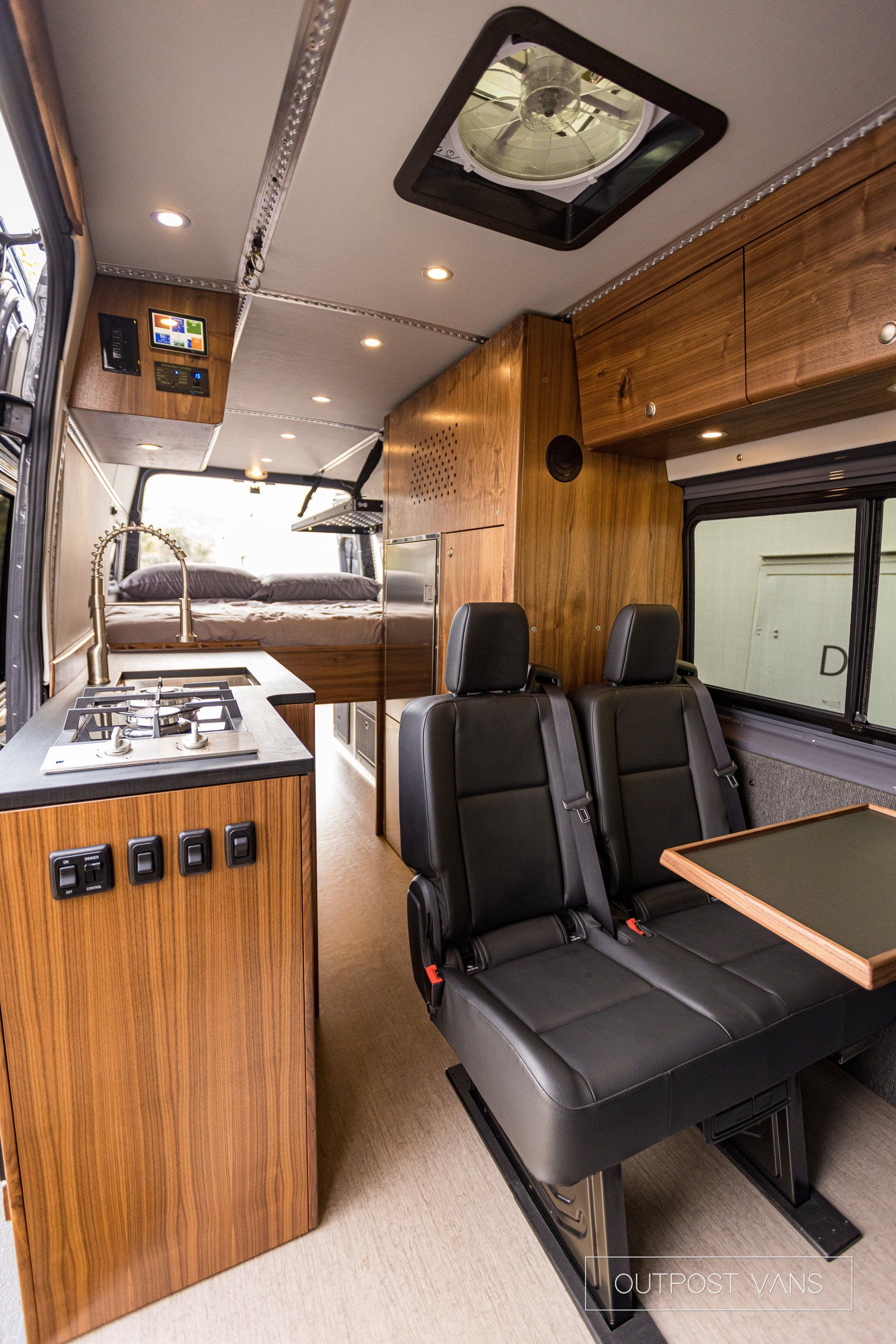 The inside of a van with a table and chairs.
