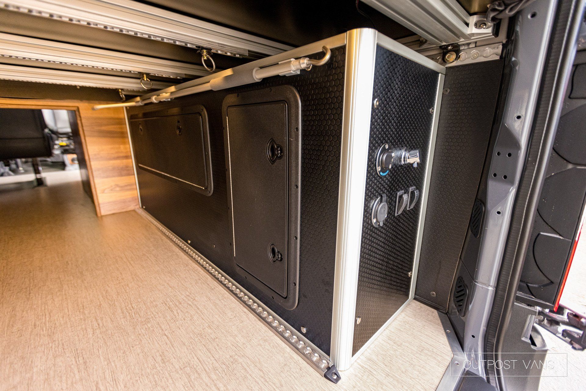 A van with a lot of storage space underneath it.