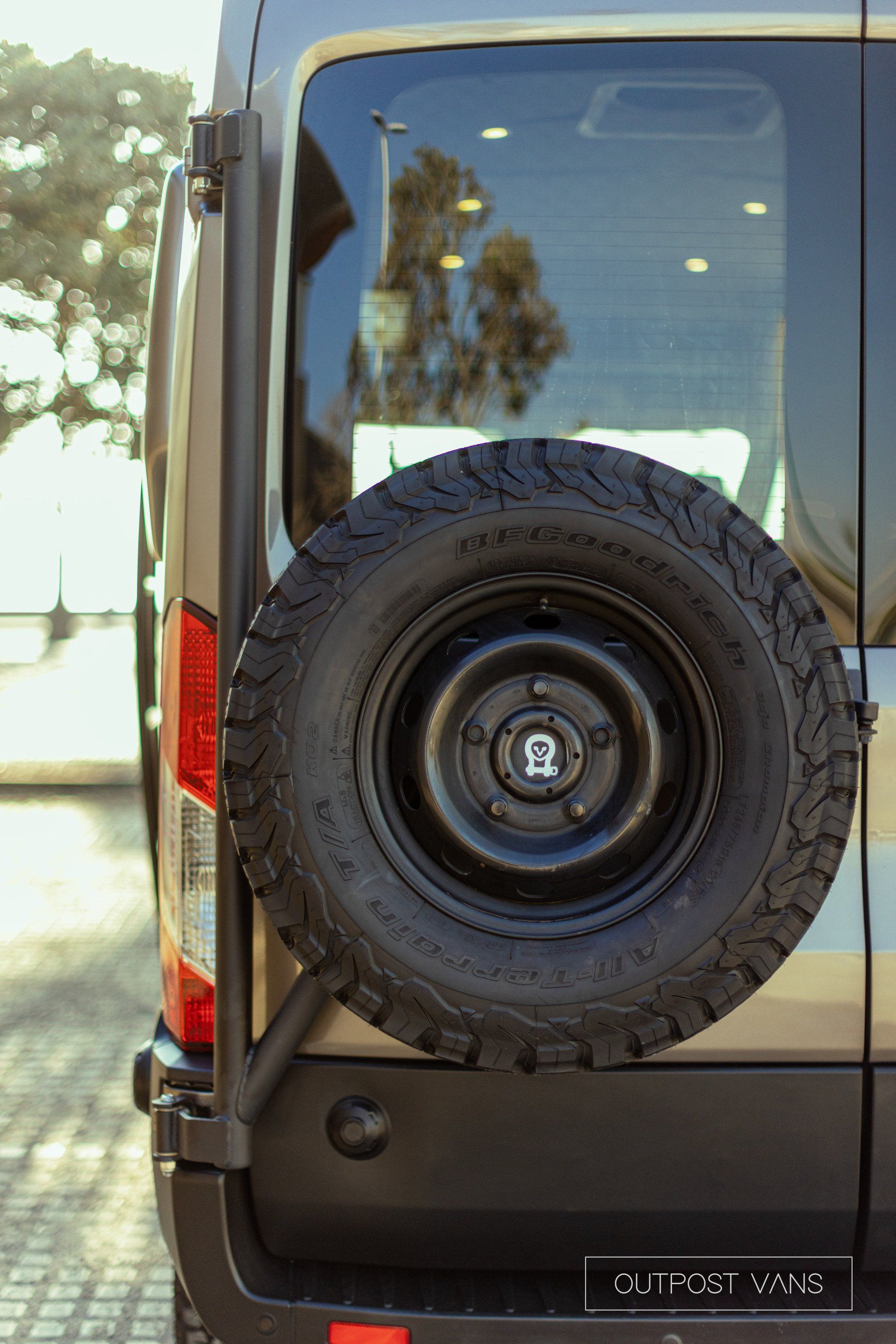 the back of a van with a spare tire attached to it .