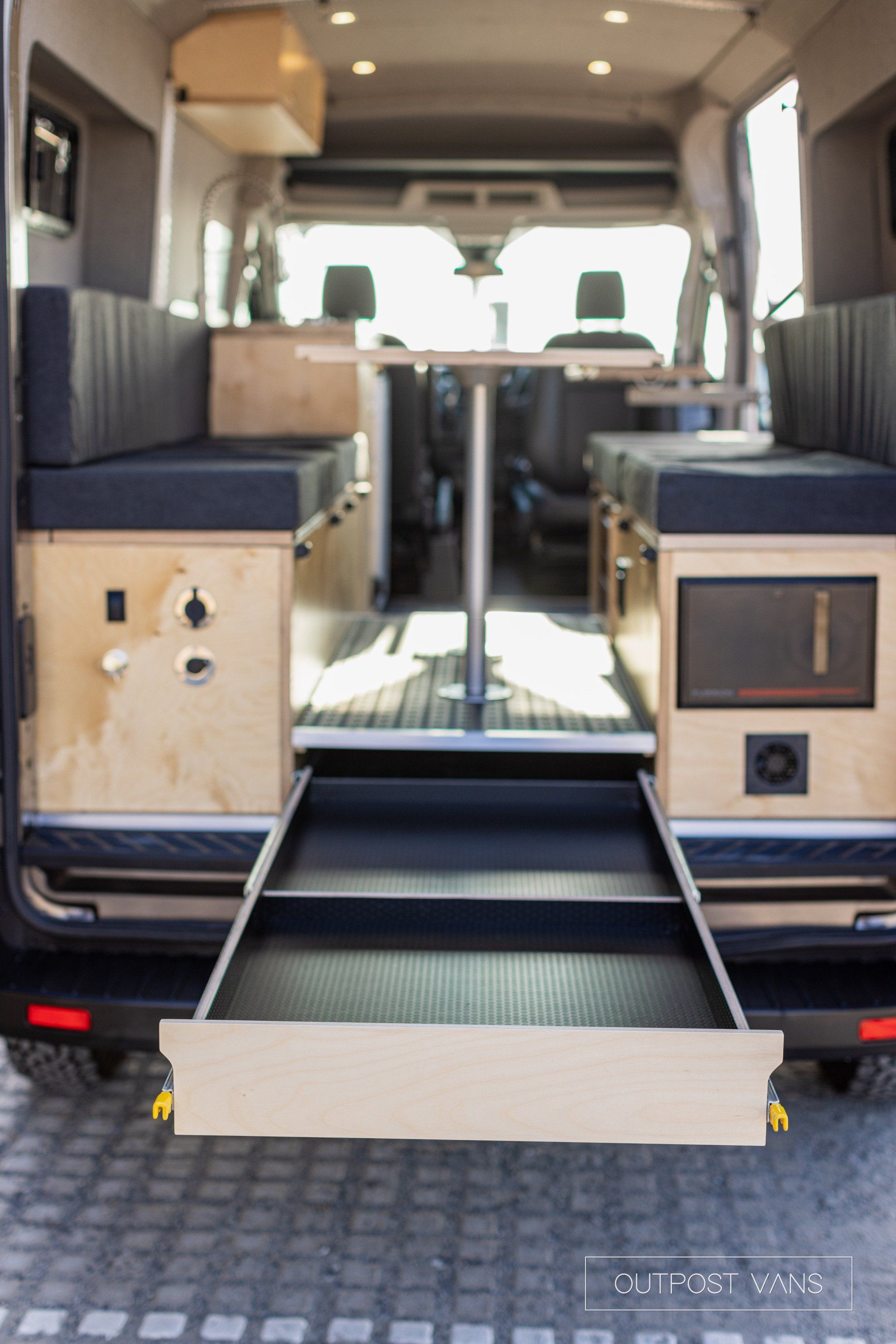 a camper van with a drawer in the back of it .