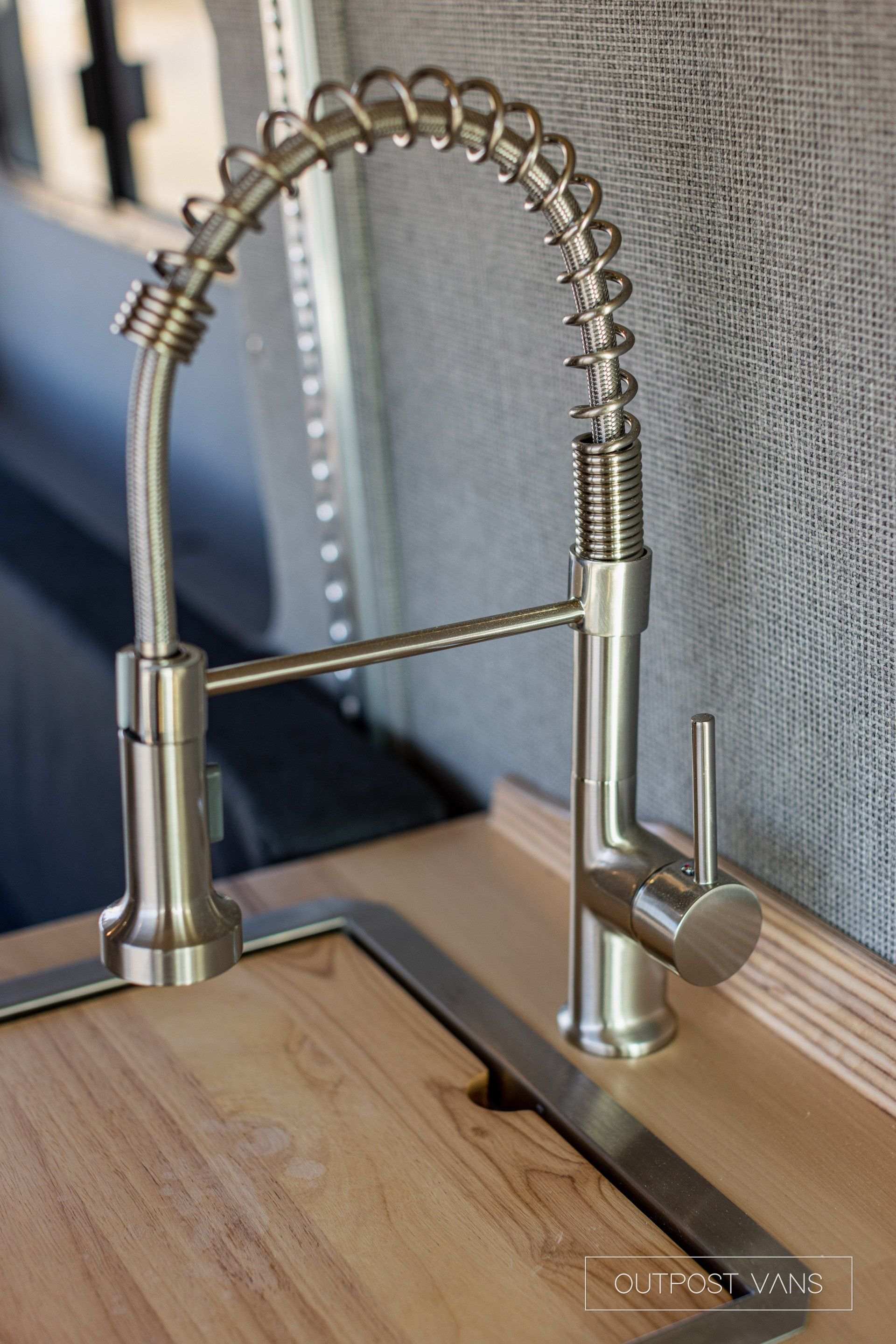 a kitchen sink with a stainless steel faucet