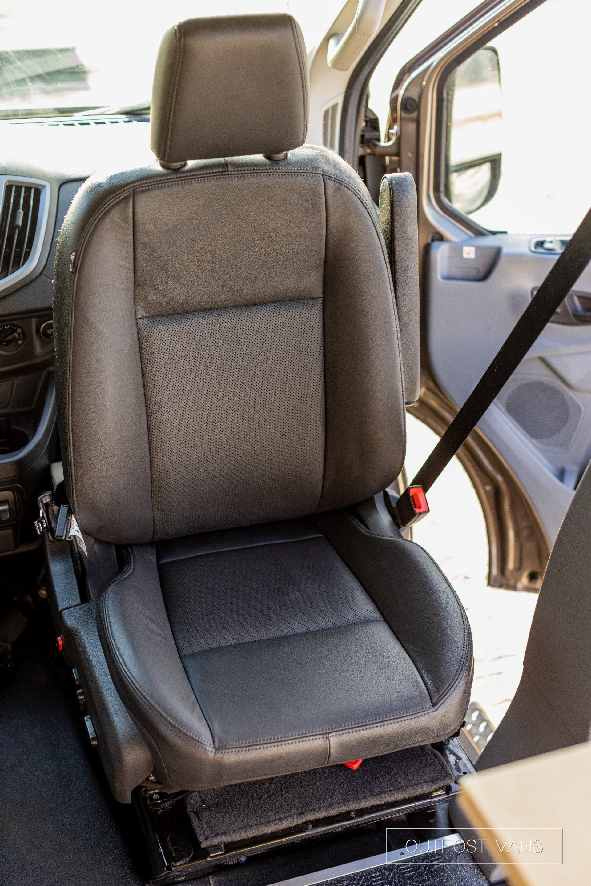 a car seat is sitting in the back of a van with the door open .