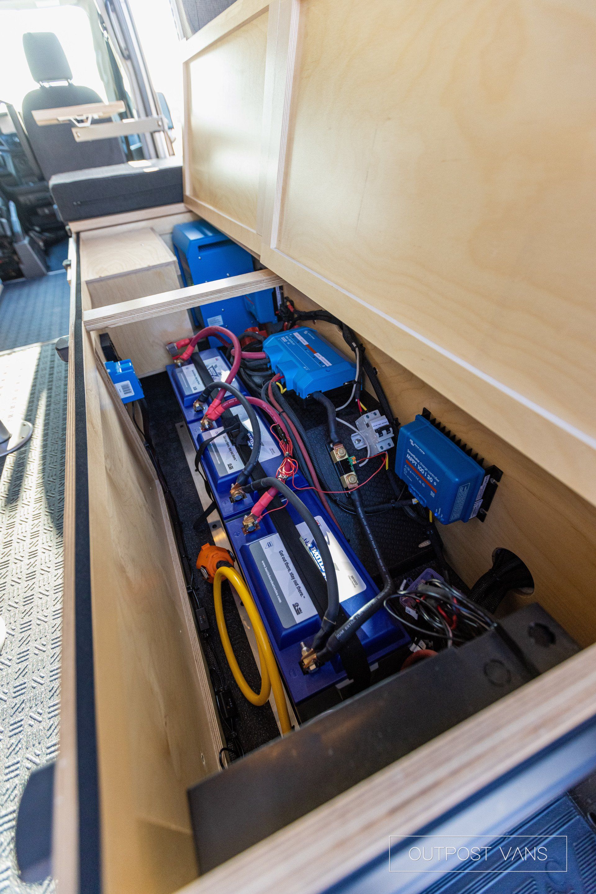 a bunch of batteries are sitting inside of a van .