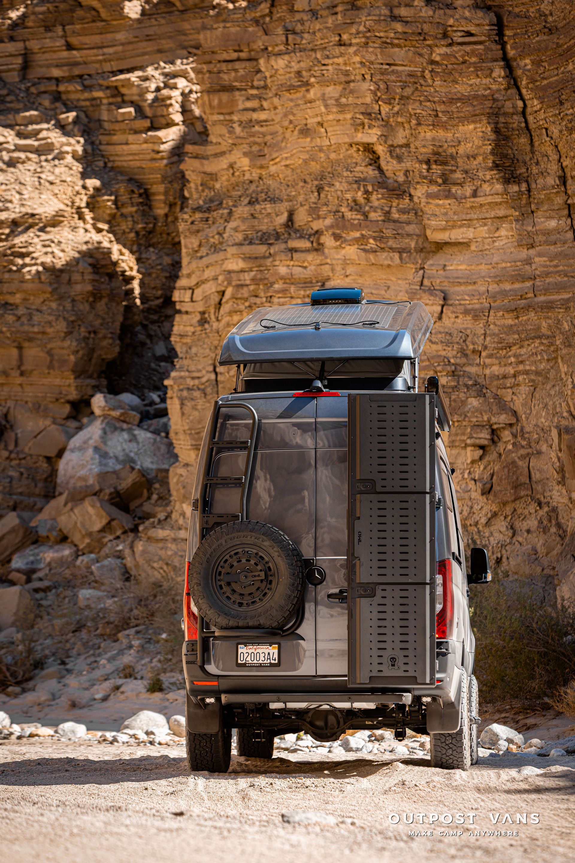A sprinter van with a sca pop åtop at Fish Creek Anza Borrego. Owl vans tire carrier and ski box