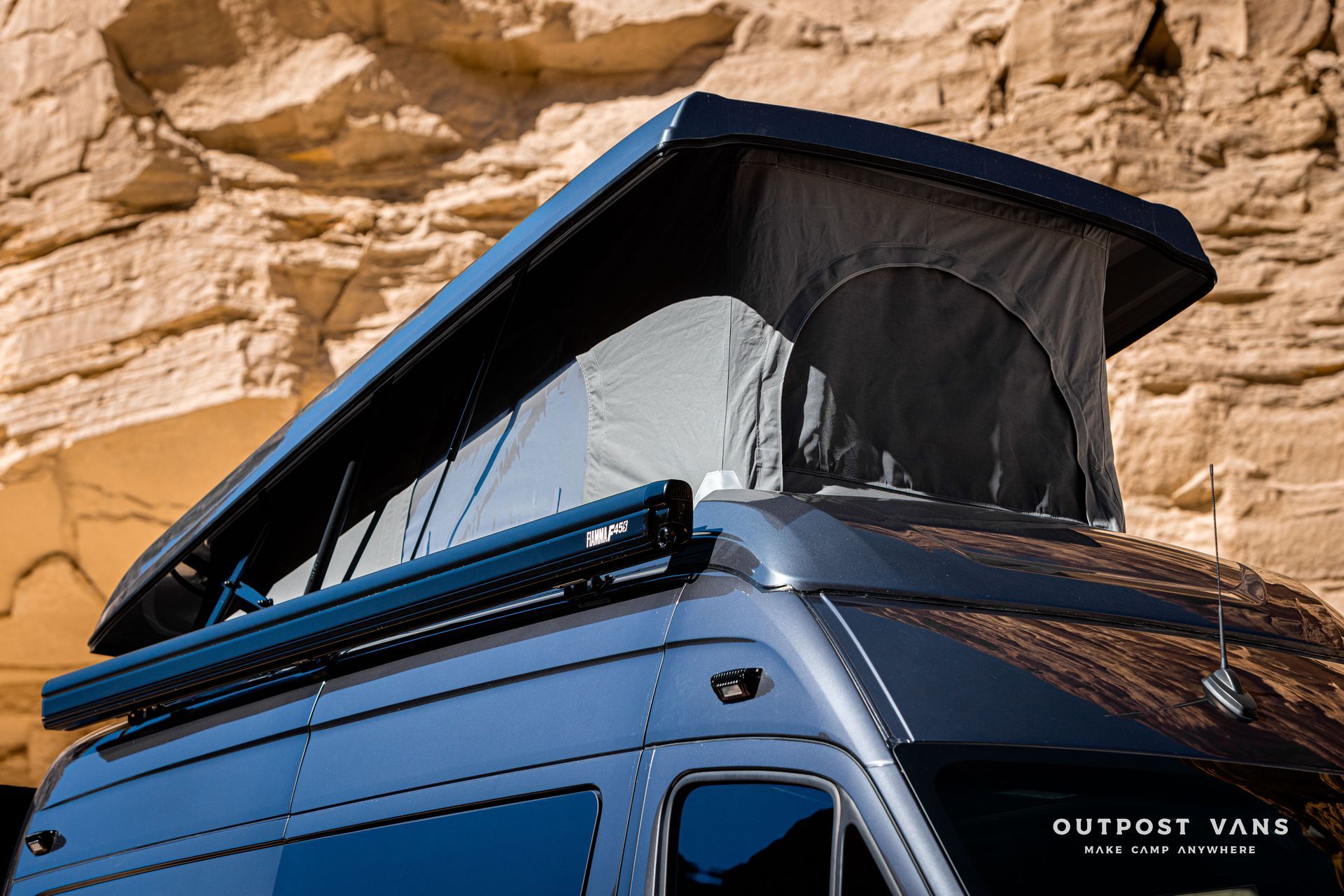 A van with a sca pop top roof is and custom brackets for Fiamma f45s awning