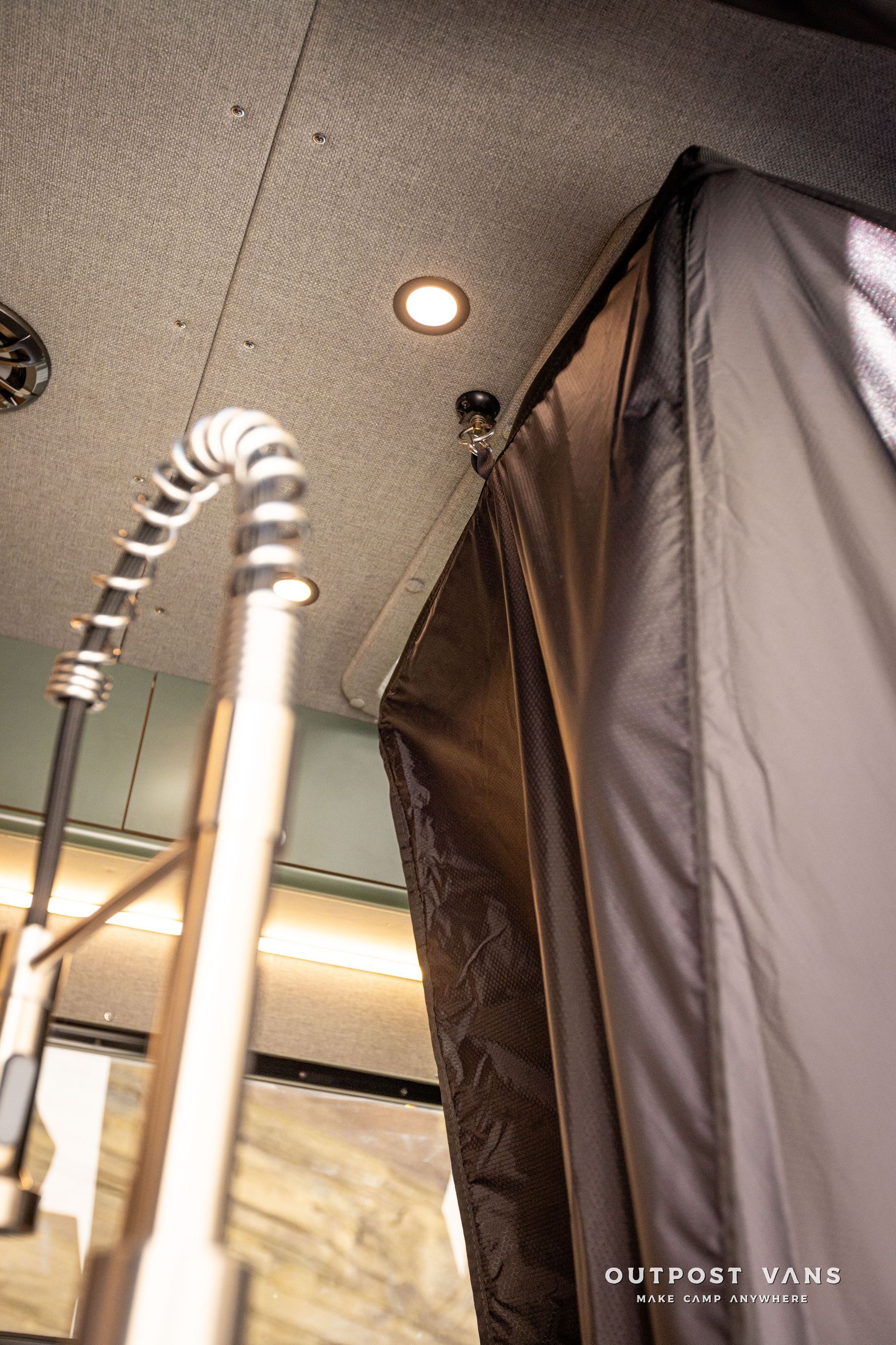 Outpost vans in the floor shower pan with bamboo insert shower hose and mixer. custom shower curtain