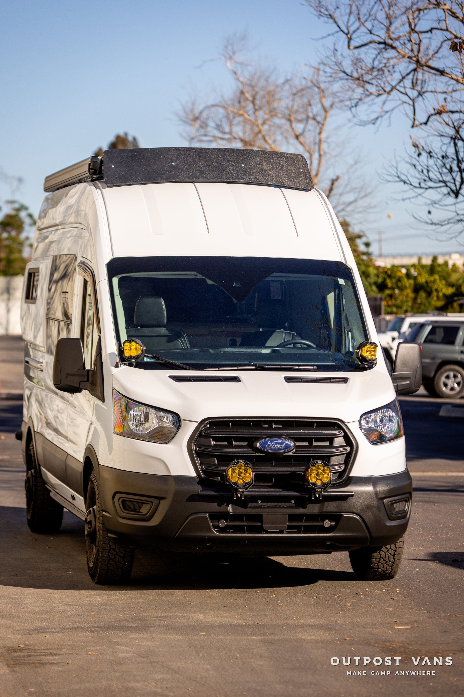 a white van is parked in a parking lot .