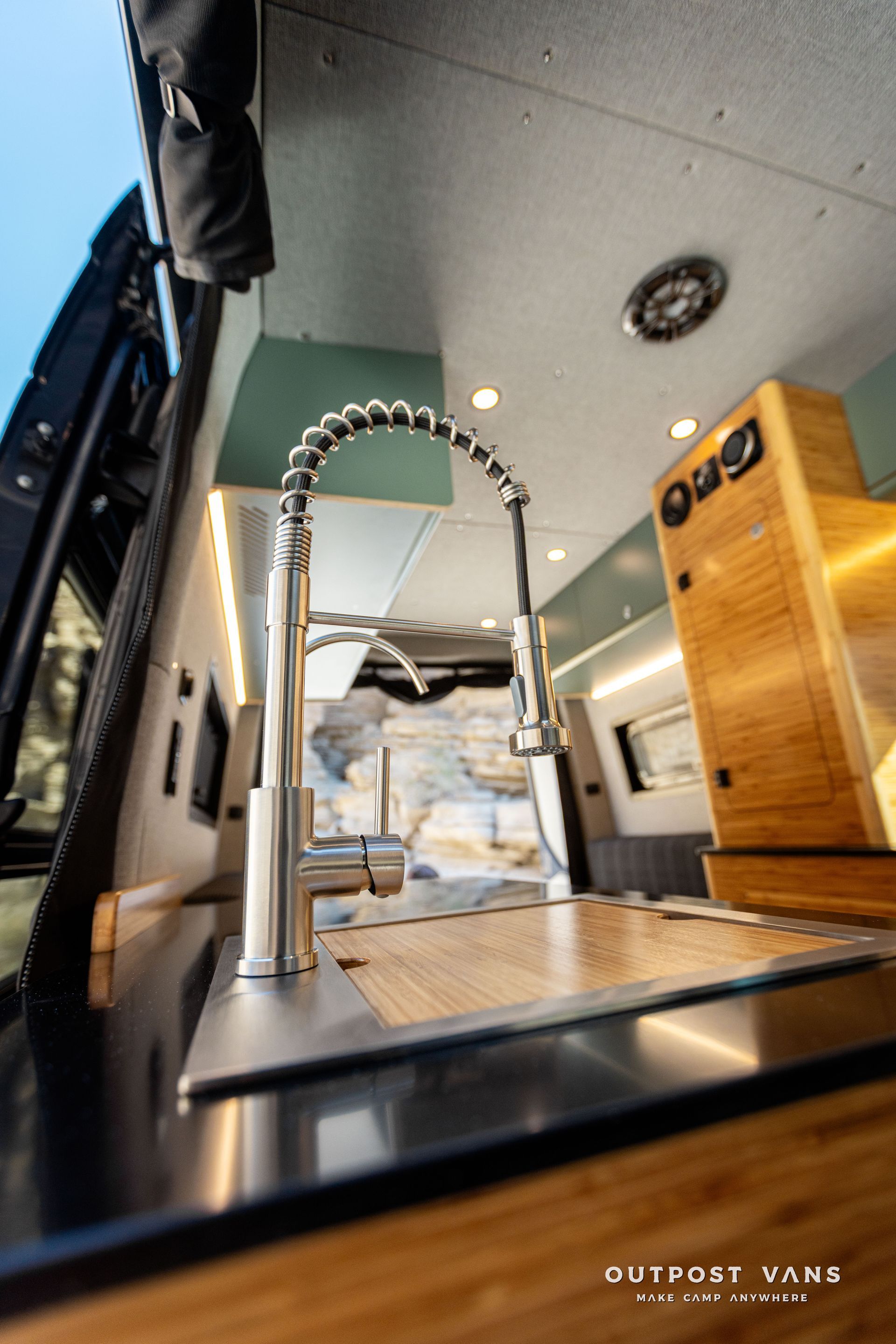 A kitchen sink with a faucet in a van.