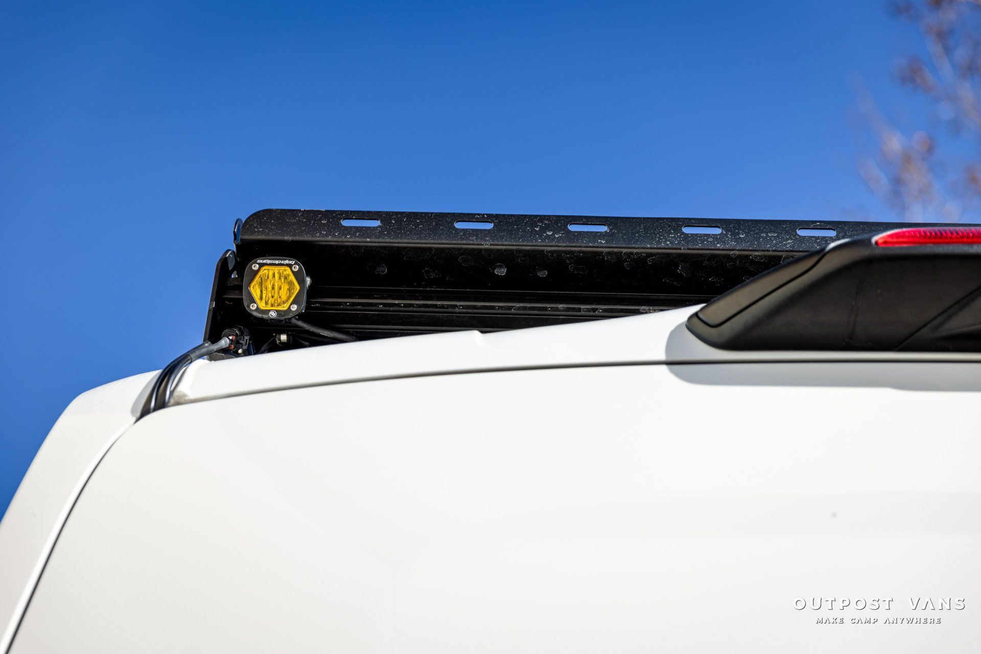 a white van with a roof rack and lights on it .