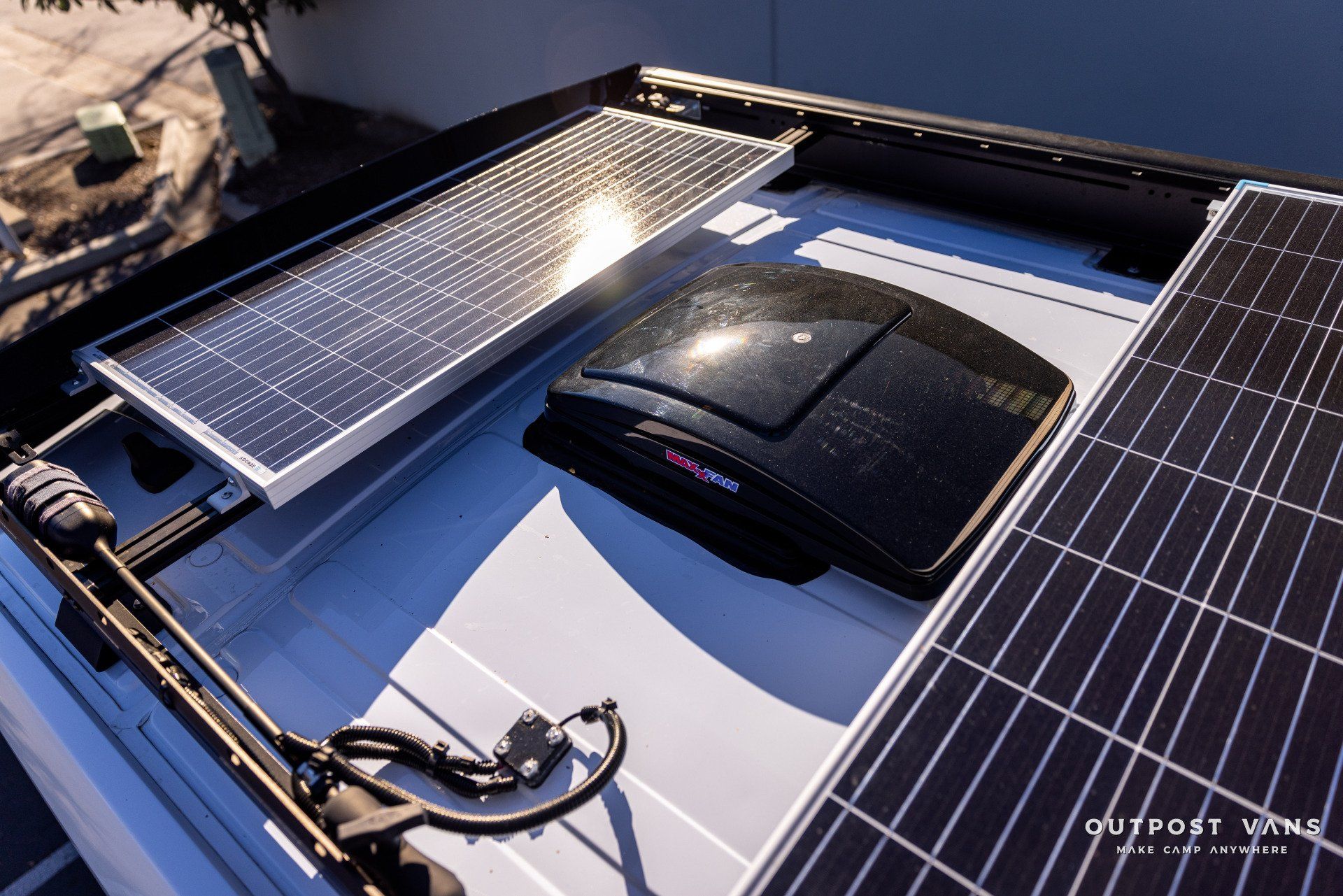a roof with solar panels and a fan on it