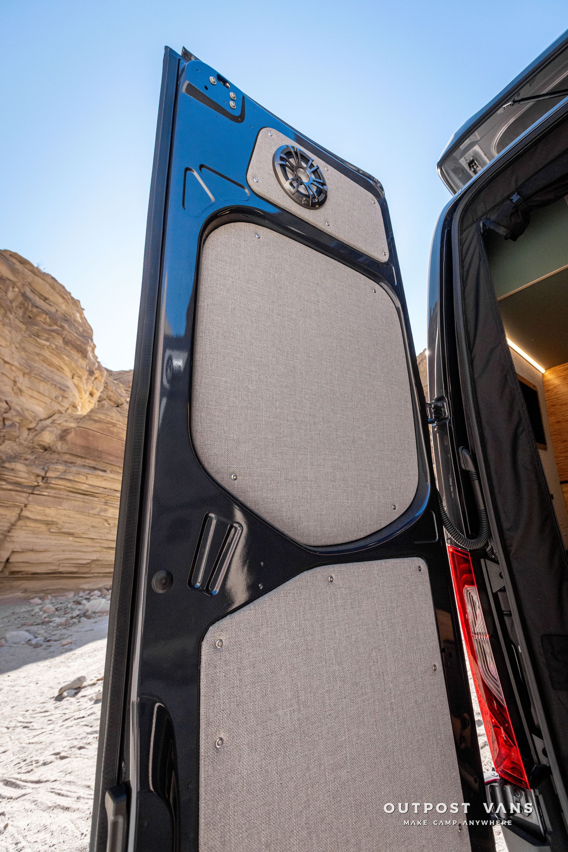 A close-up of the back of a van with the door open. rear door speakers
