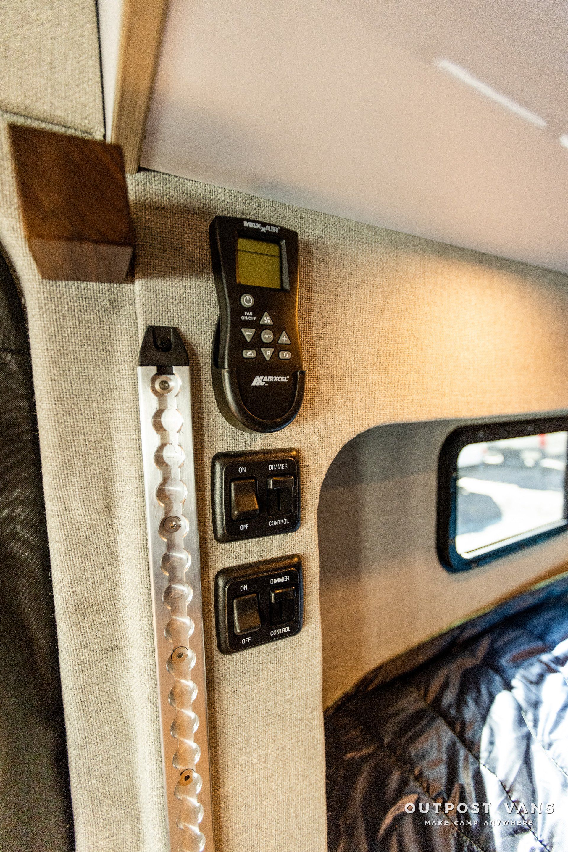 a remote control is hanging on the wall of a camper van .