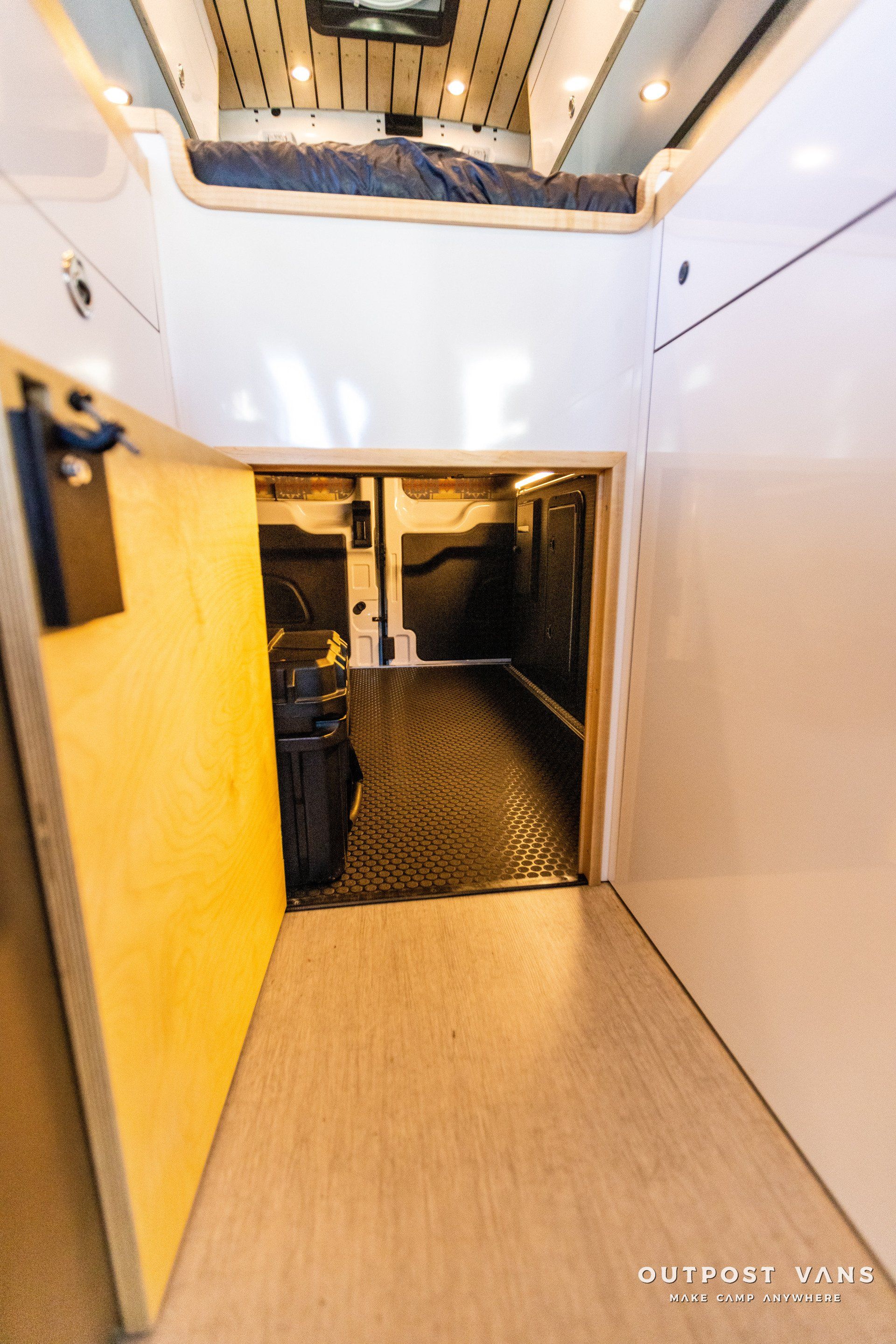 a long hallway leading to a bedroom in a camper van .