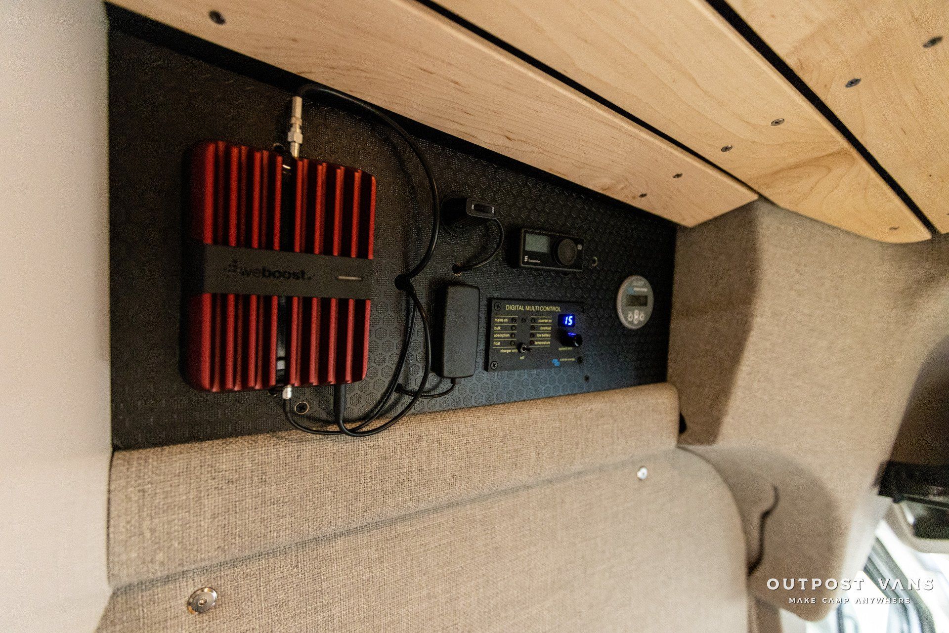 a red device is hanging on a wall in a room .