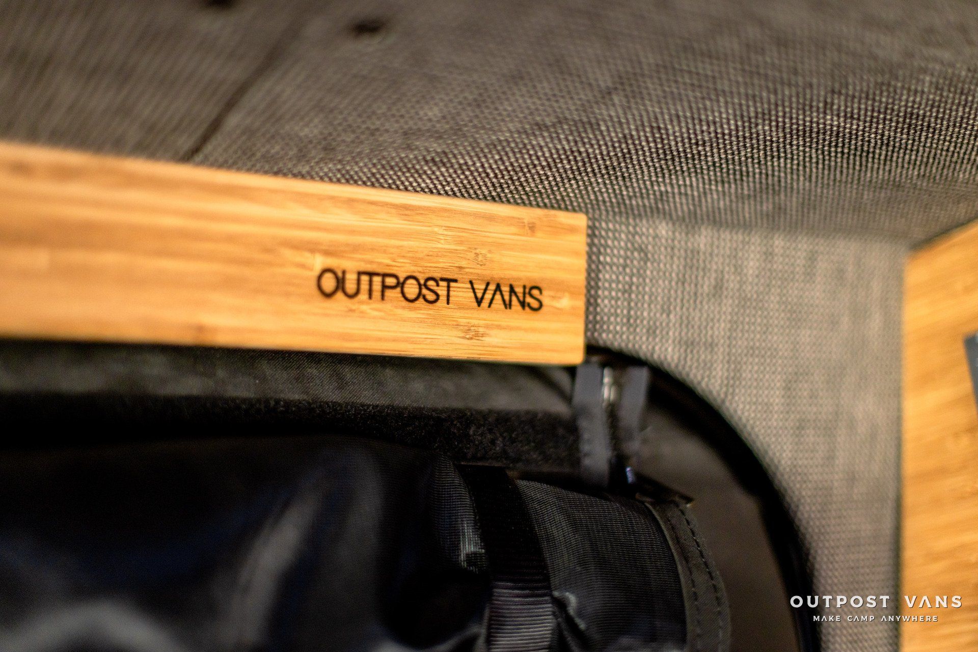 A wooden shelf with the word outpost vans written on it.