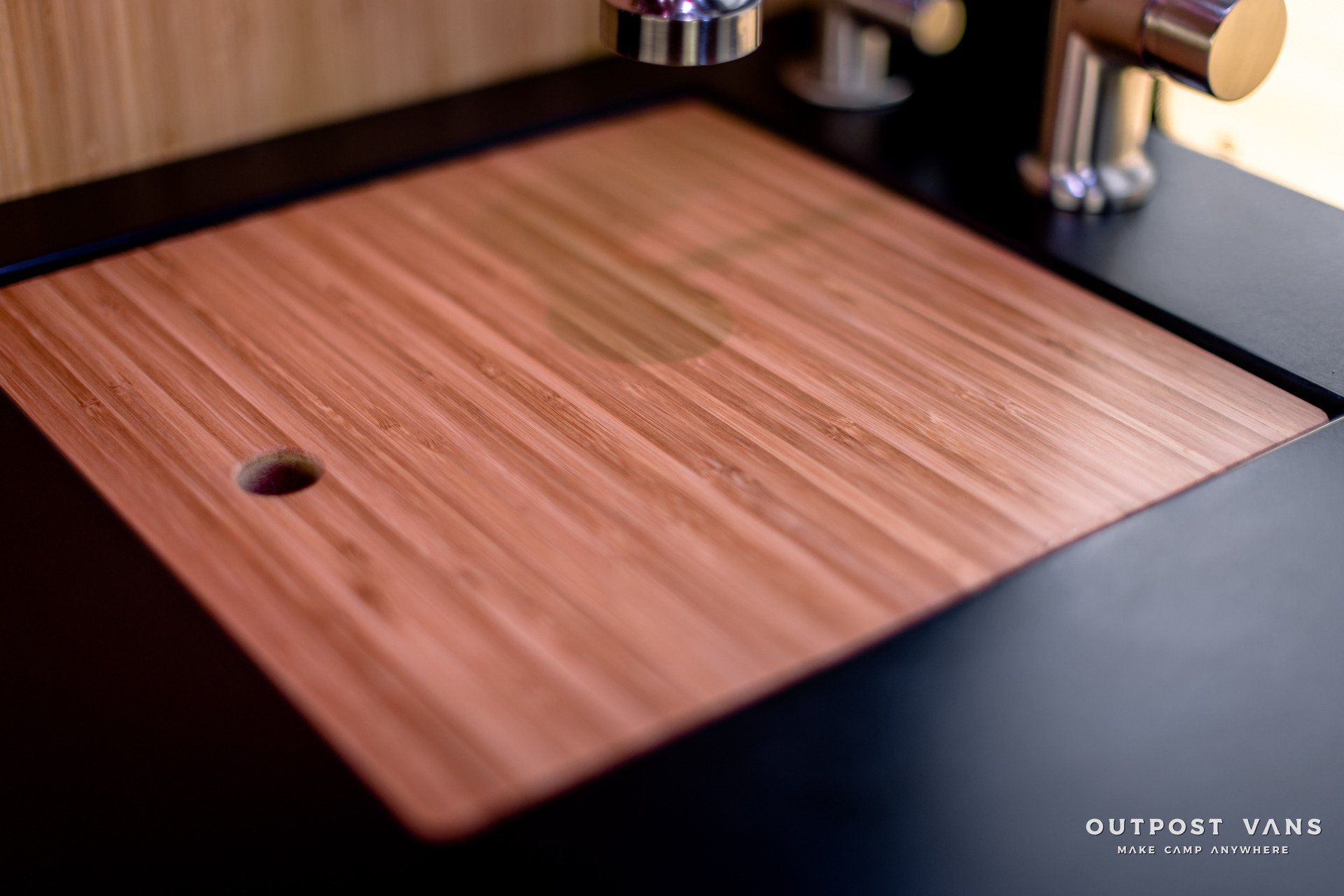 A wooden sink with a hole in the middle of it