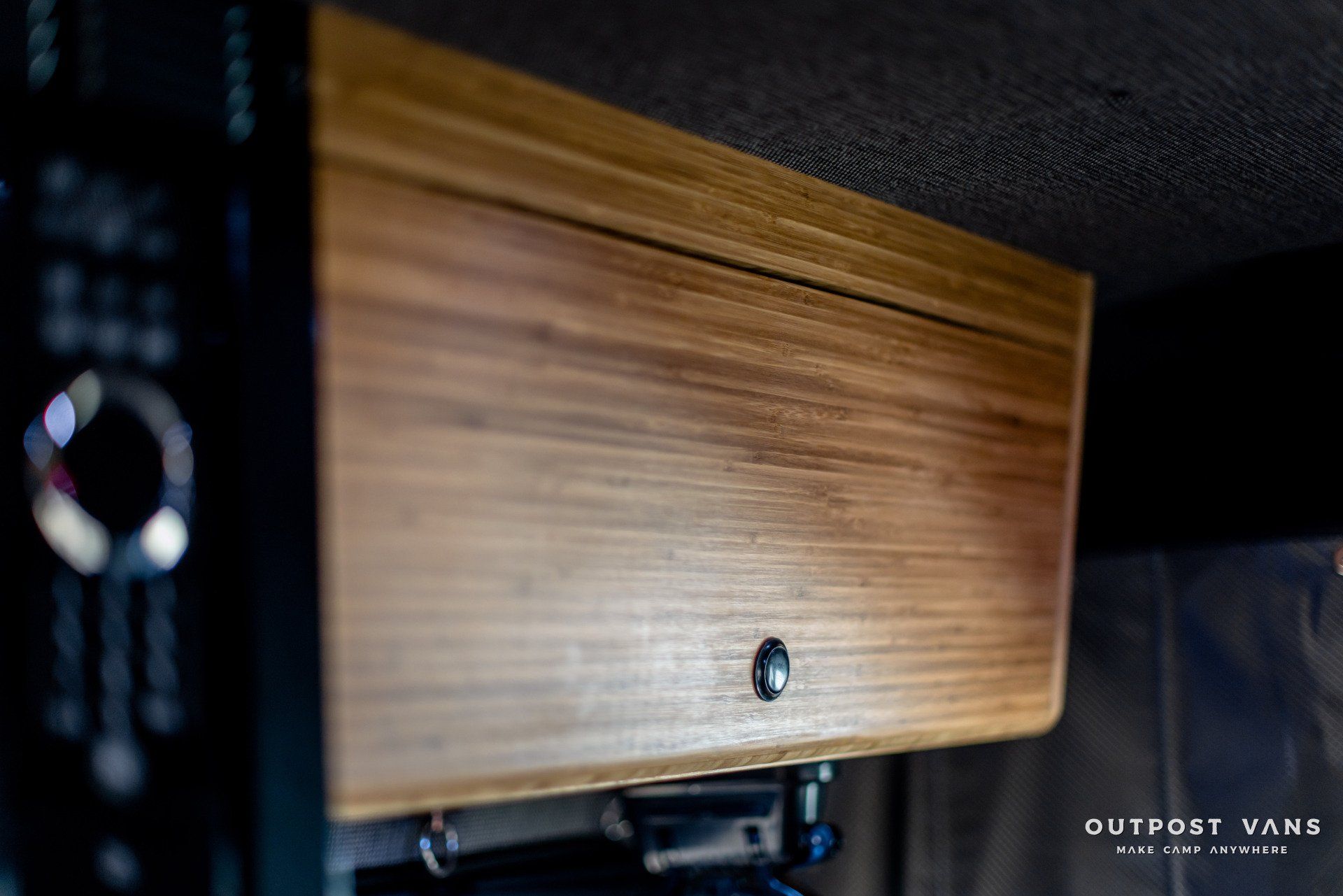 A close up of a wooden cabinet in a van.