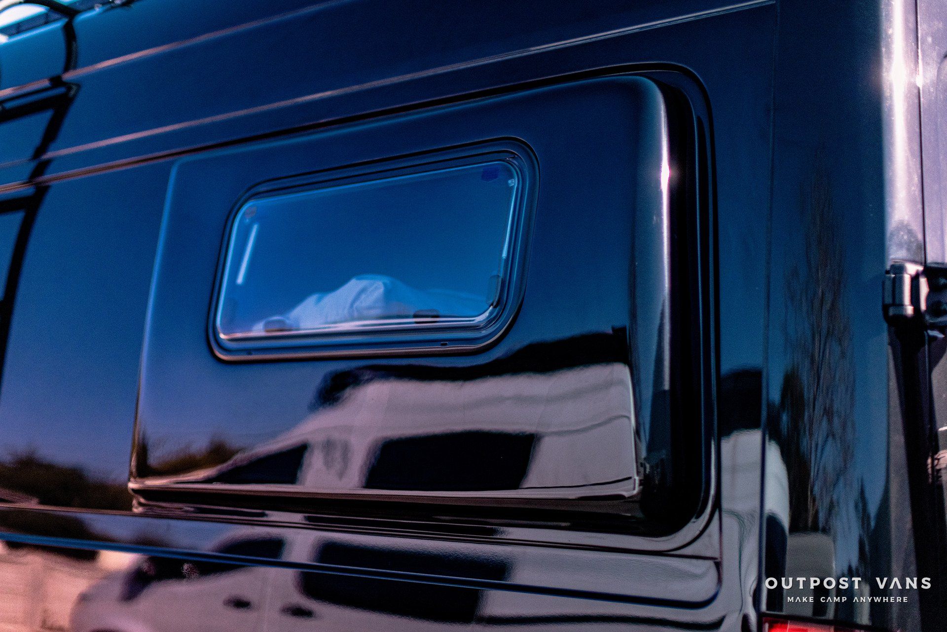 A black van with a window on the side of it.