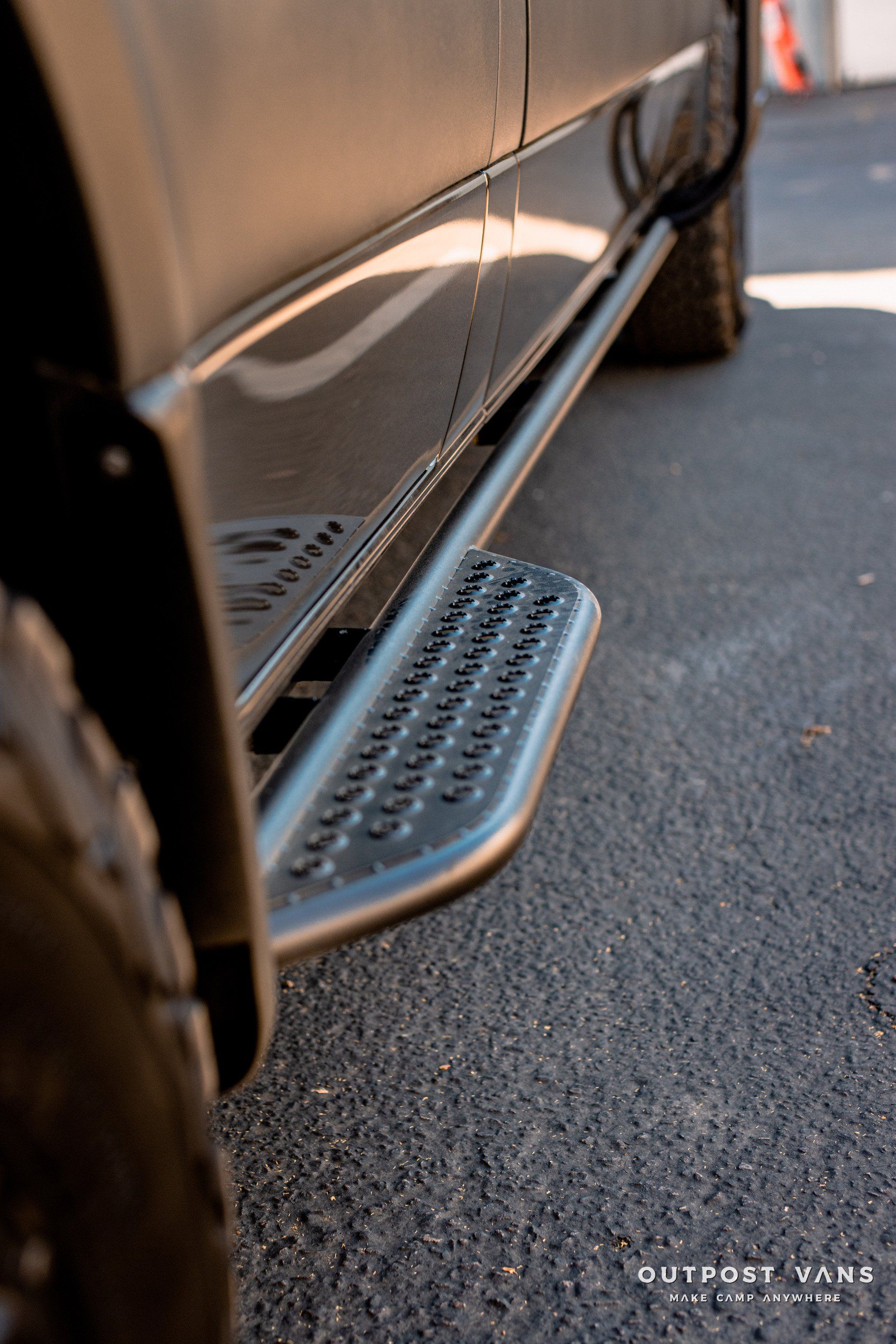 A close up of a side step on a car.