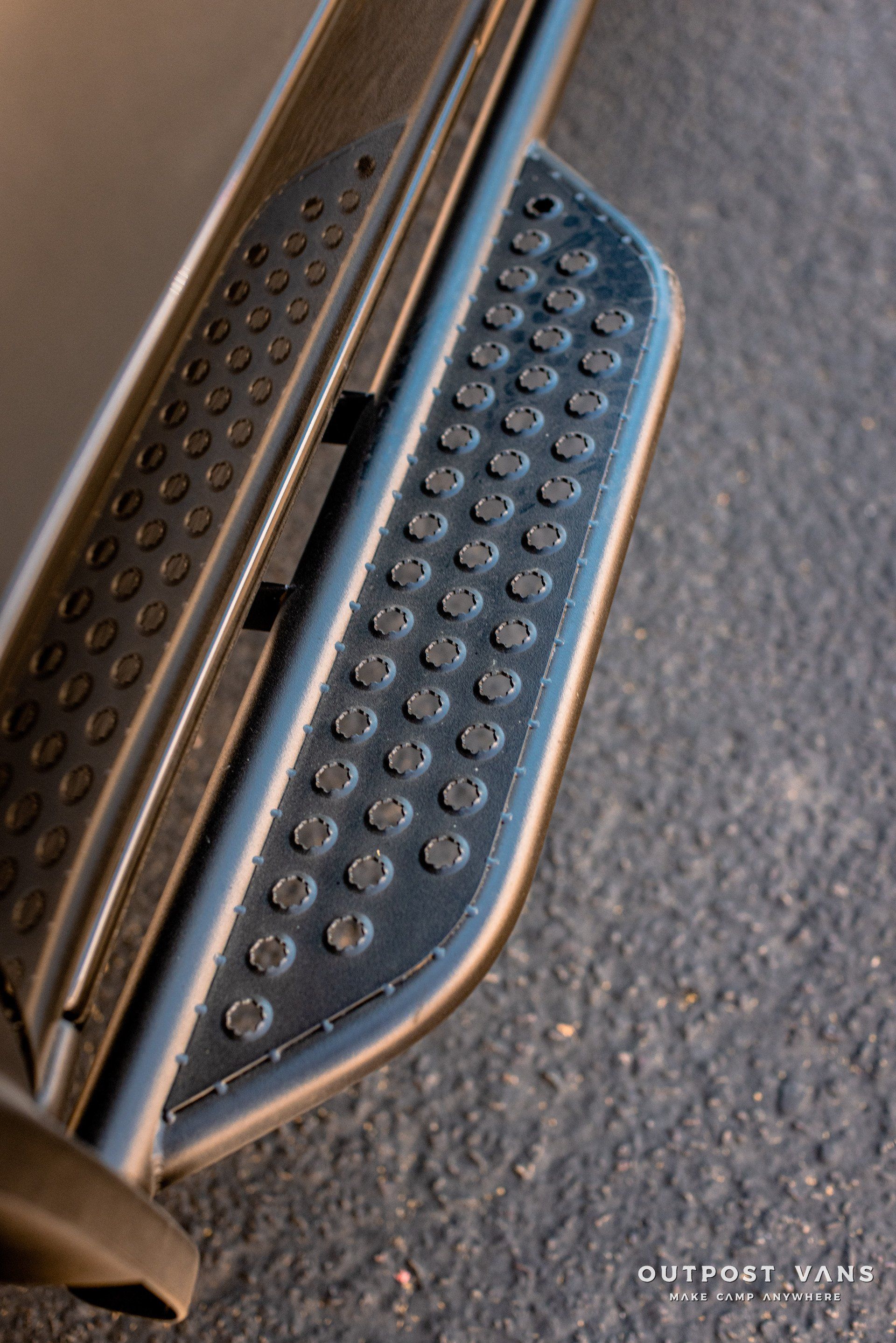 A close up of a side step on a car.