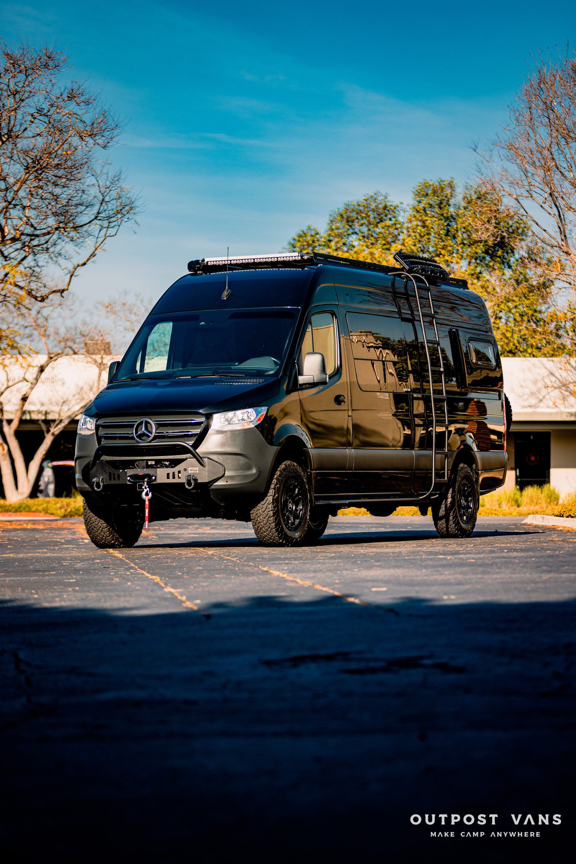 A black van is parked in a parking lot.