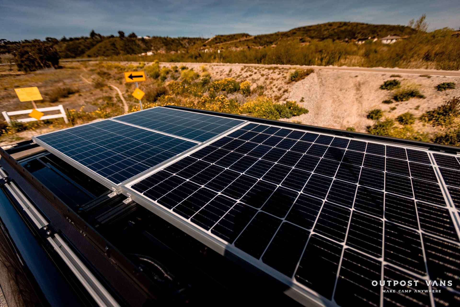 There are many solar panels on the roof of a vehicle.