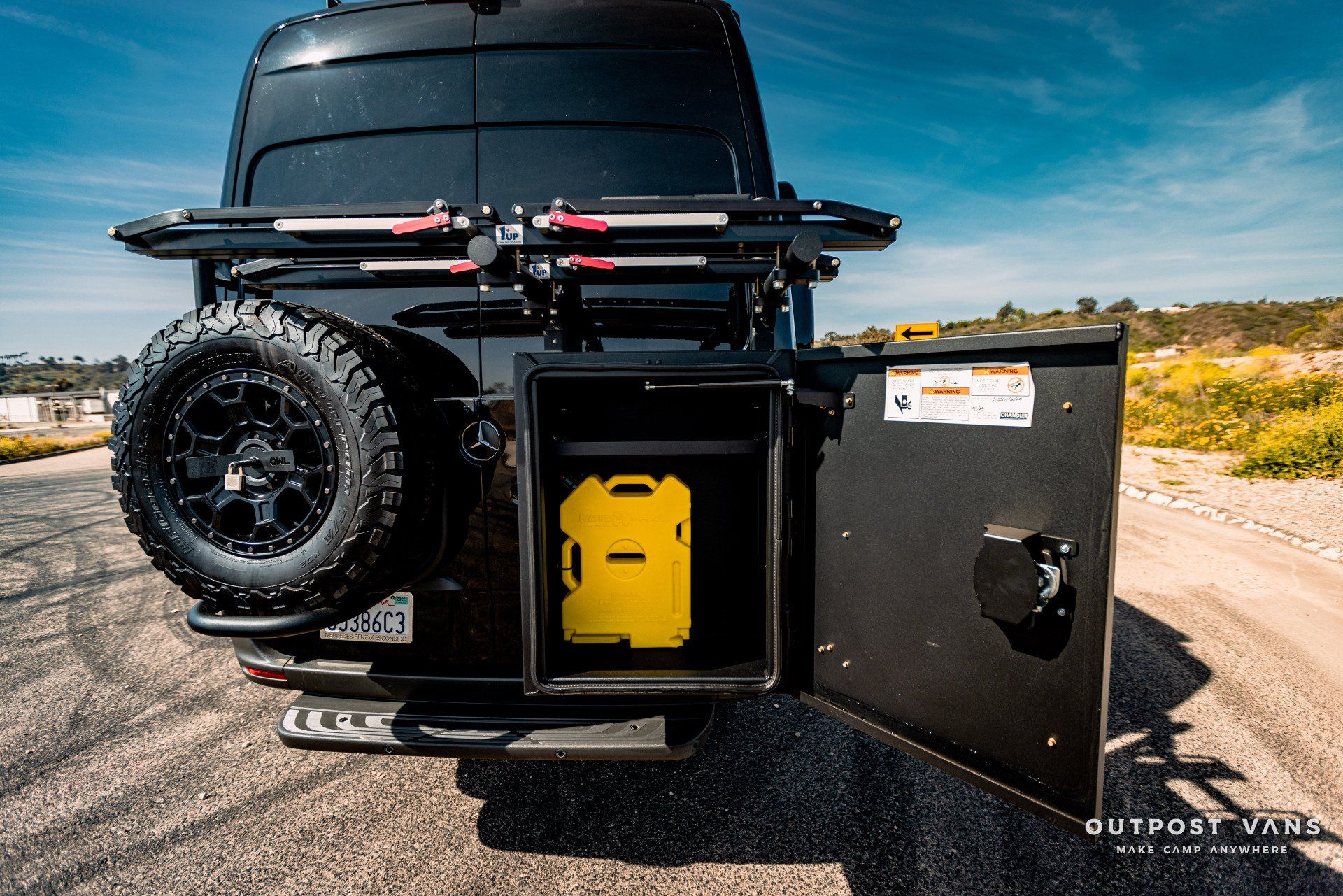 A black van with a yellow jerry can in the back
