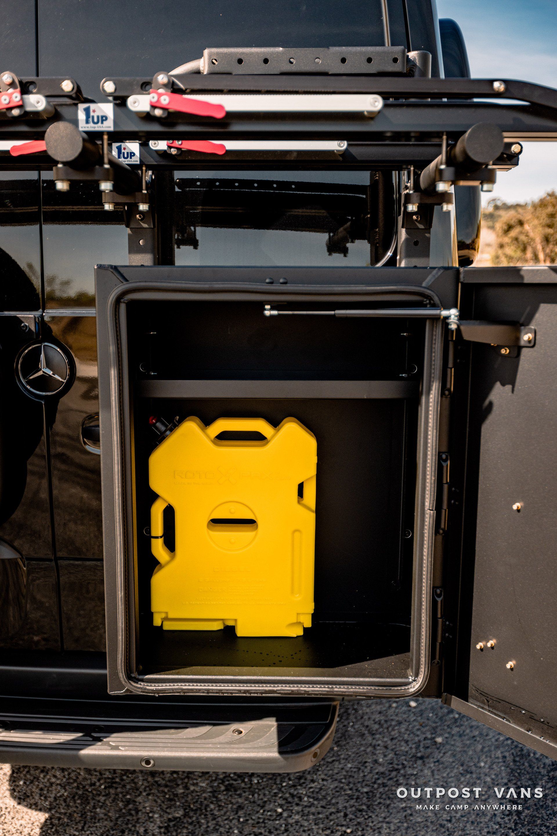 A yellow gas can is sitting in the back of a truck.