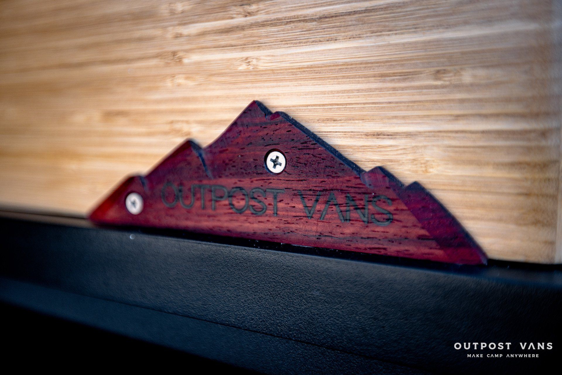 A wooden mountain with the word outpost on it