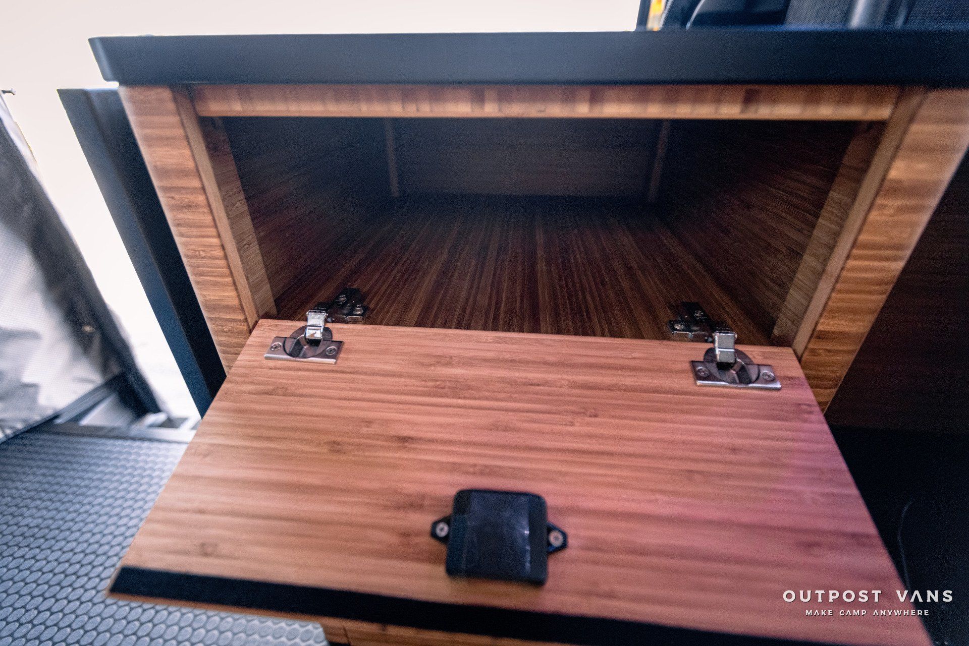 The inside of a wooden cabinet with the door open.