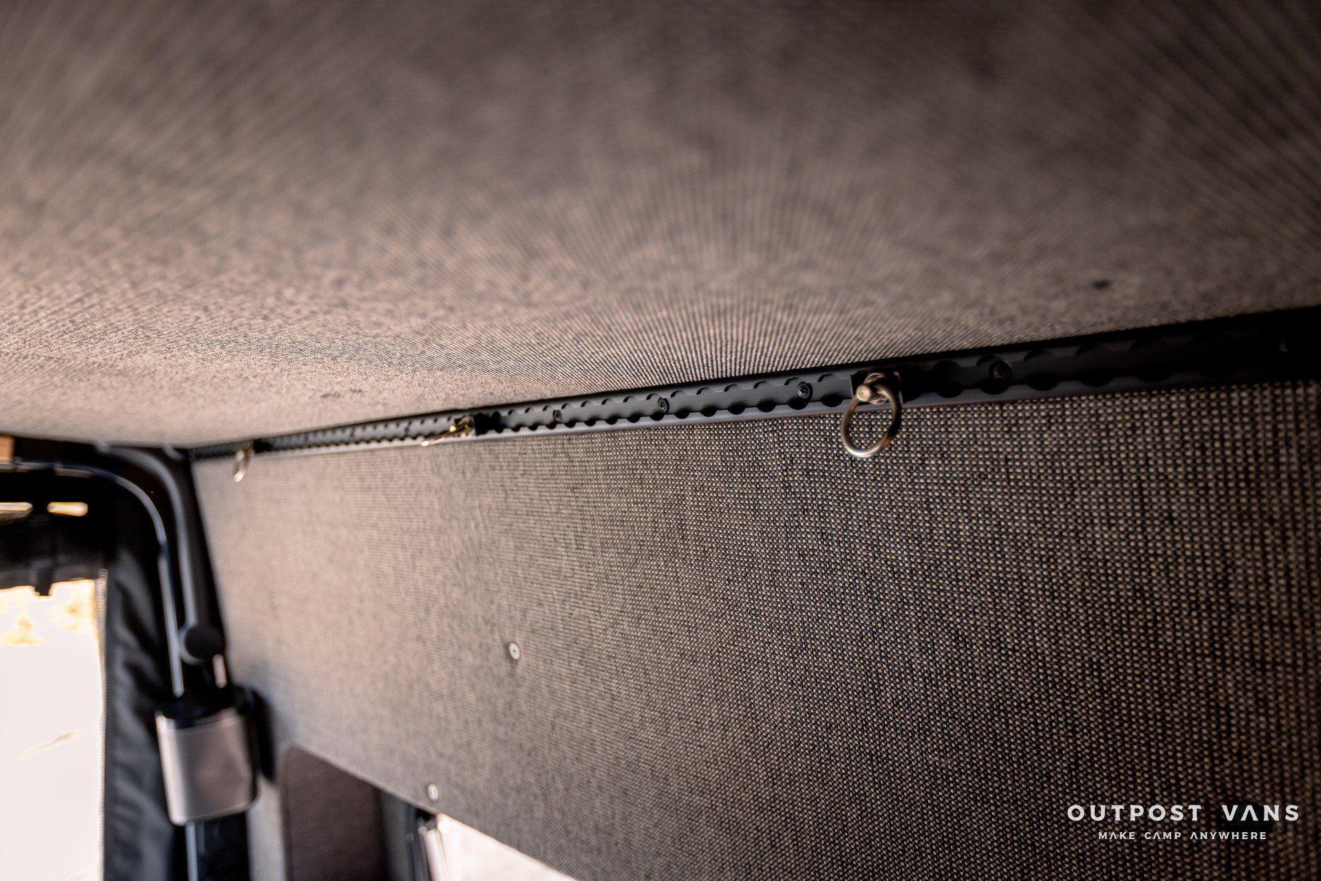 A close up of a ceiling with a hook on it.