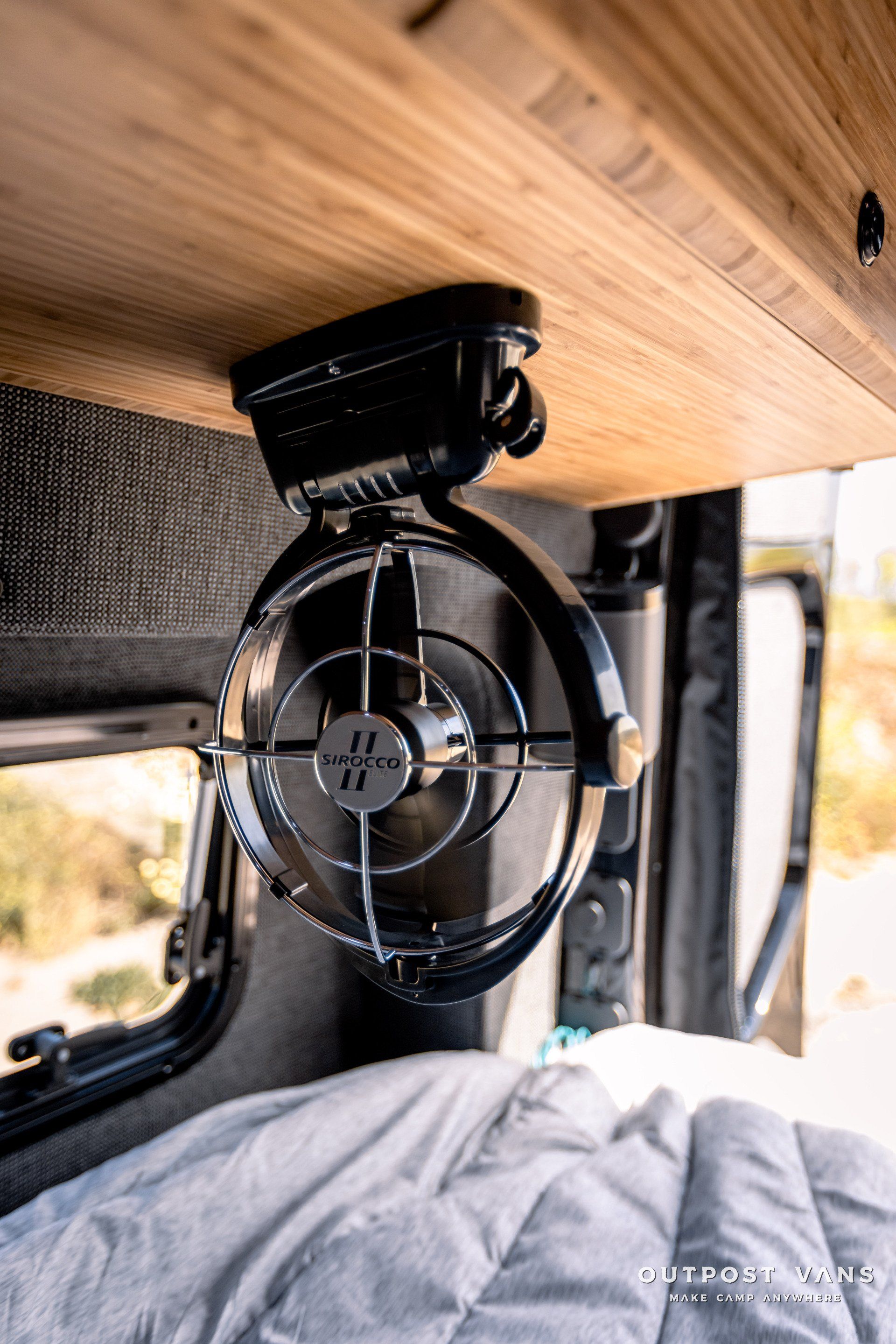 A fan is hanging from the ceiling of a van.