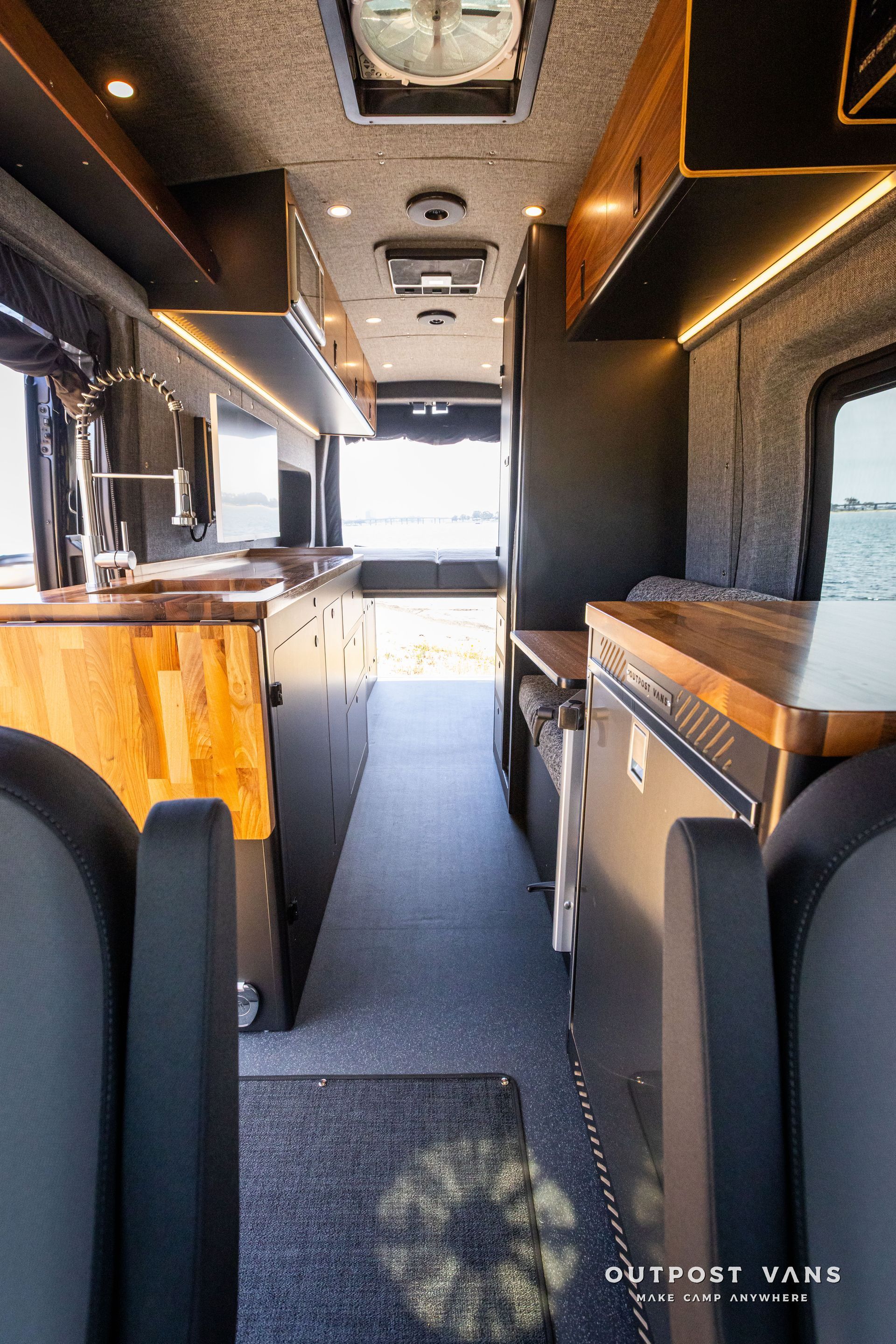 Outpost Vans custom built camper van Ford Transit 148 AWD. 12v fridge isotherm cruise 130 drawer.