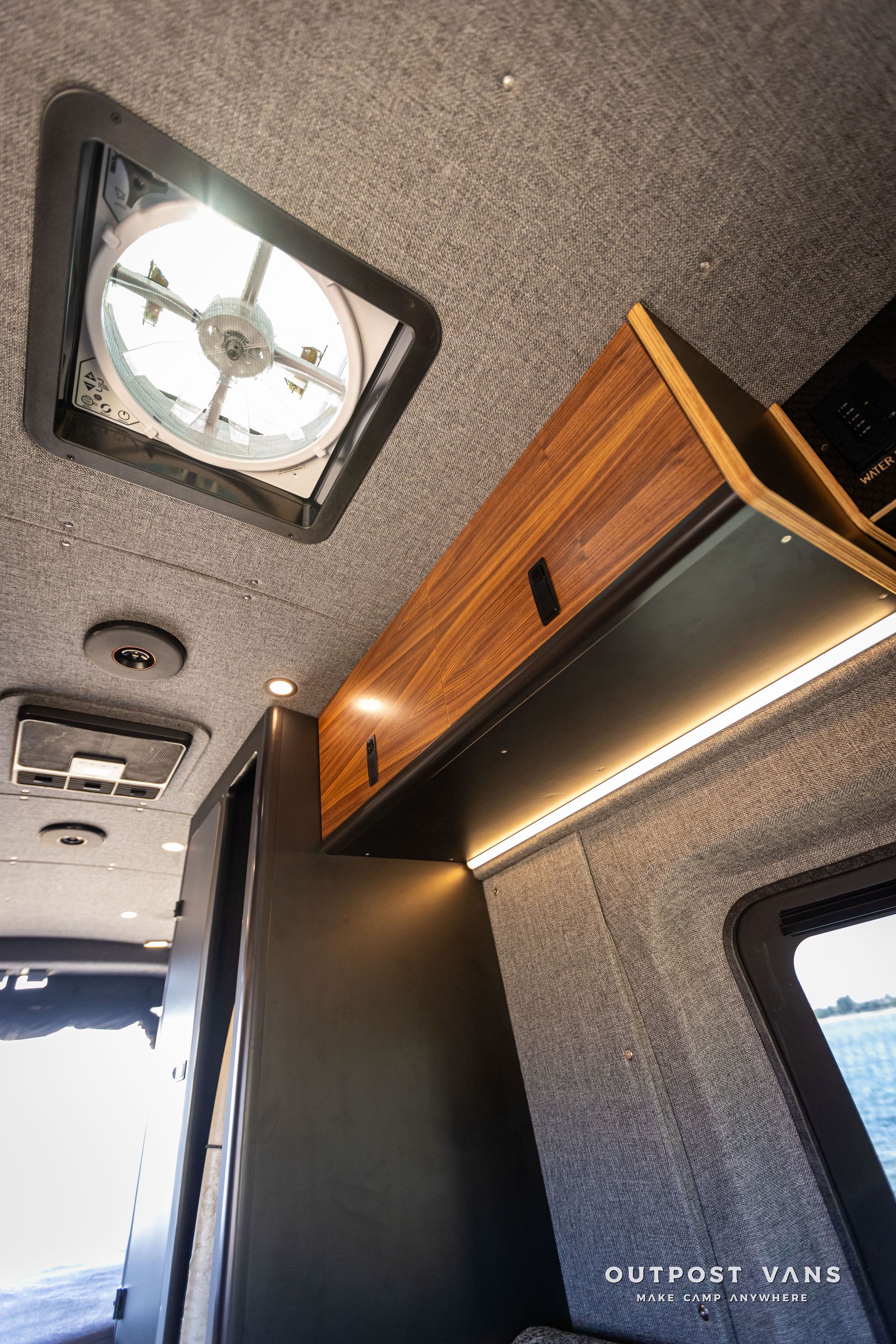 Outpost Vans custom built camper van Ford Transit 148 AWD. There is a fan on the ceiling of the van.