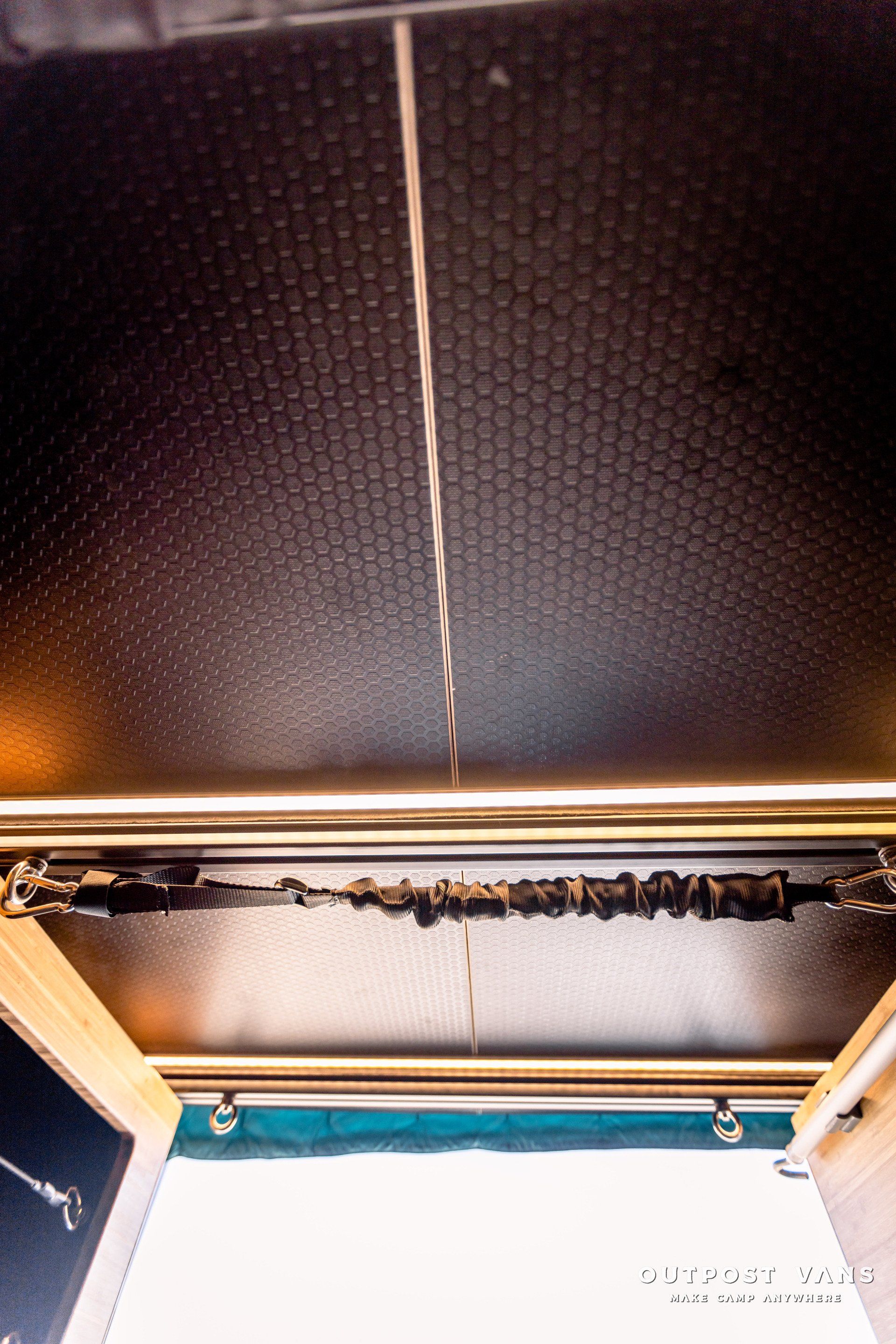 A close up of a ceiling with a few wires hanging from it.