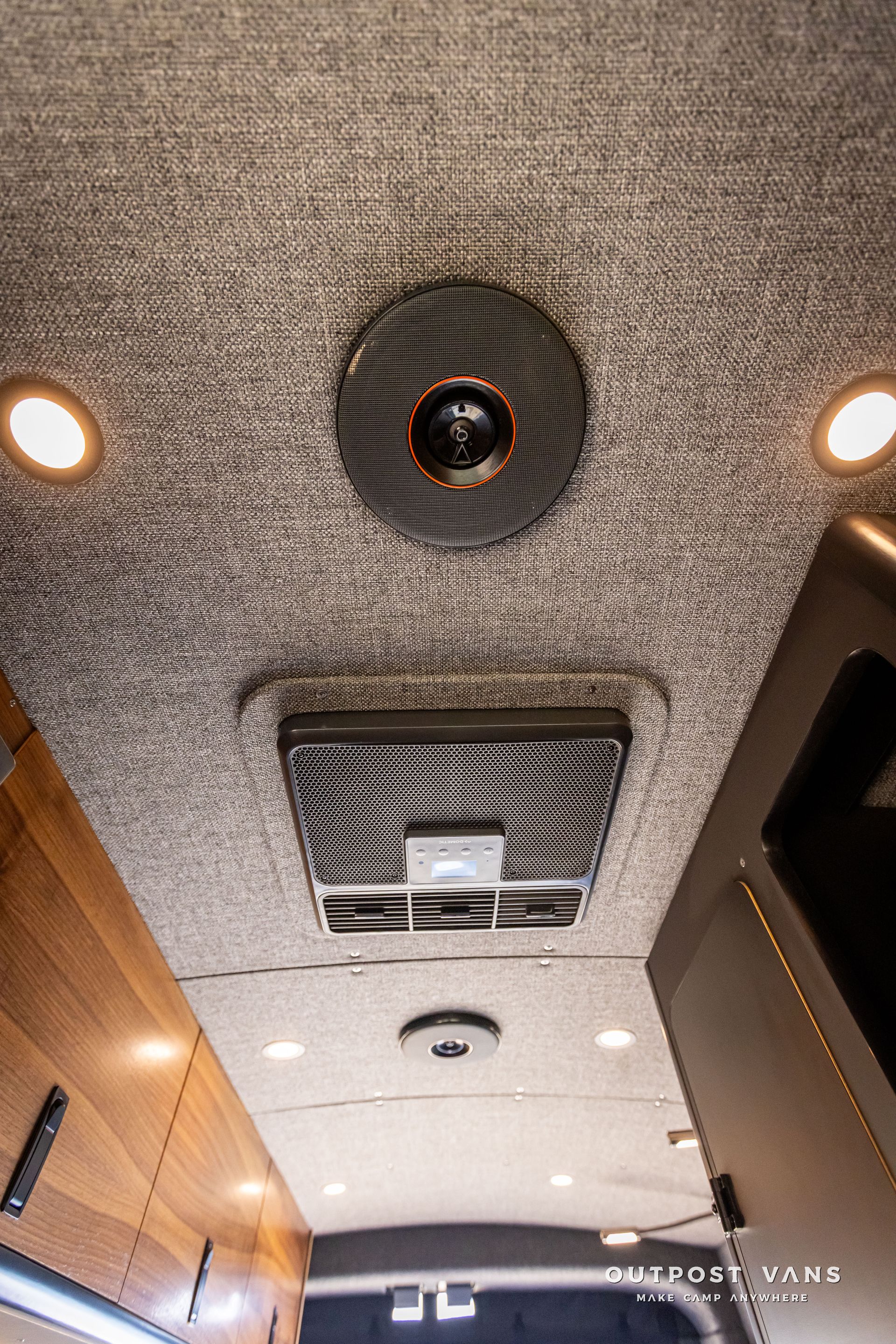 Outpost Vans custom built camper van Ford Transit 148 AWD. A ceiling fan is hanging from the ceiling of a van.