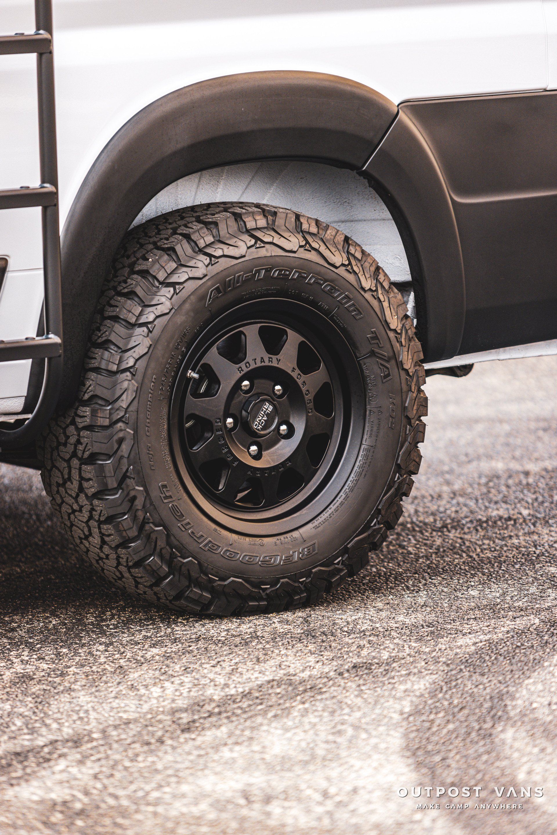 A close up of a tire on a white van.