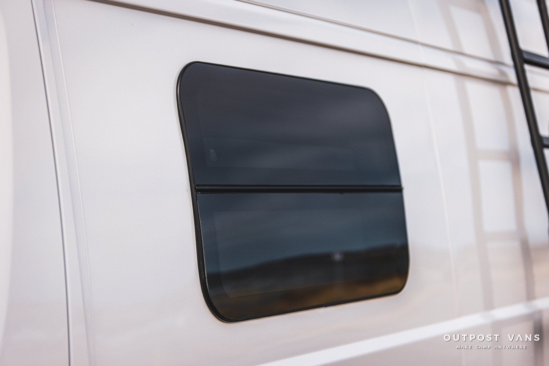 a small window on the side of a white van