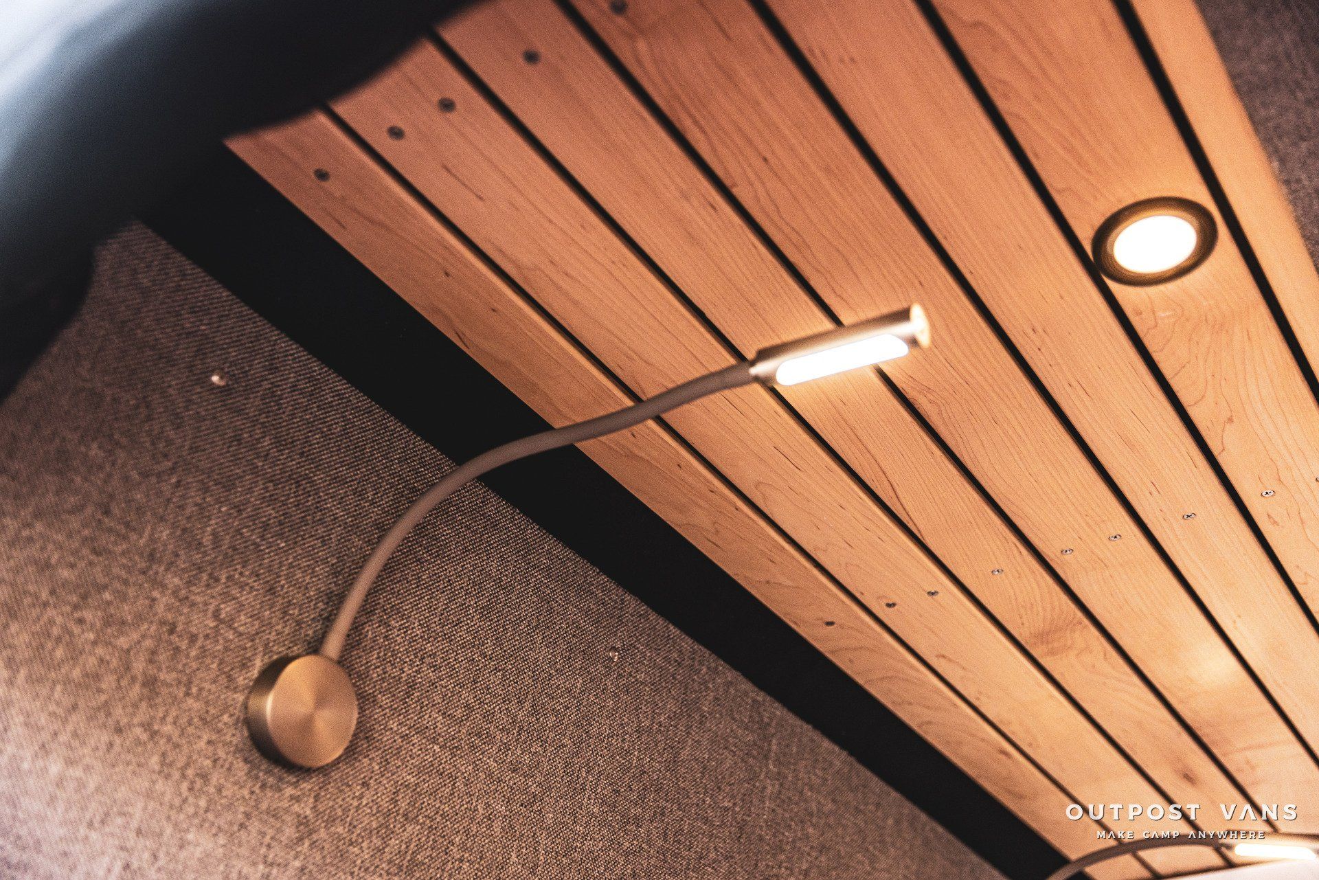 A wooden ceiling with a light hanging from it