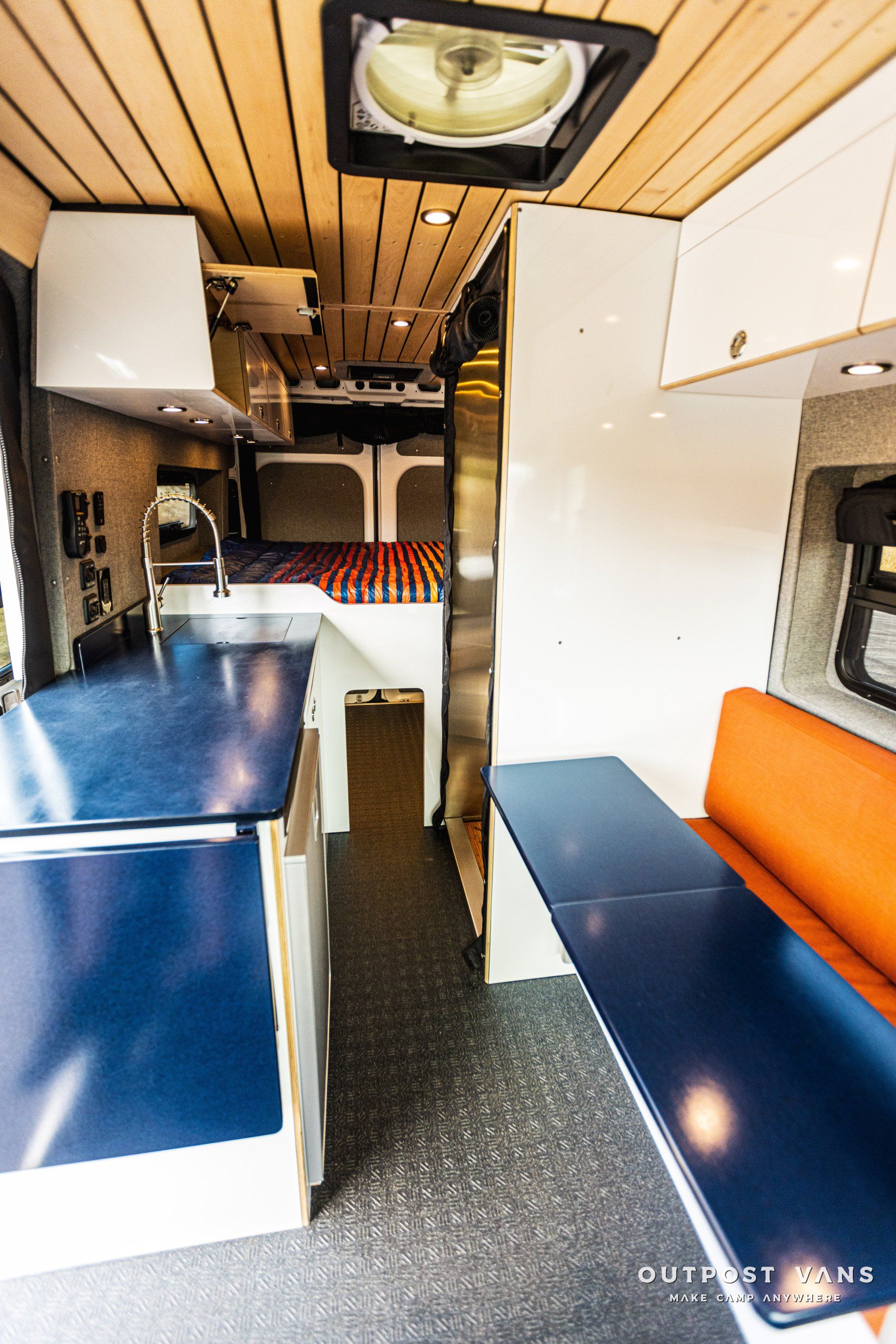 the inside of a camper van with a table and a sink