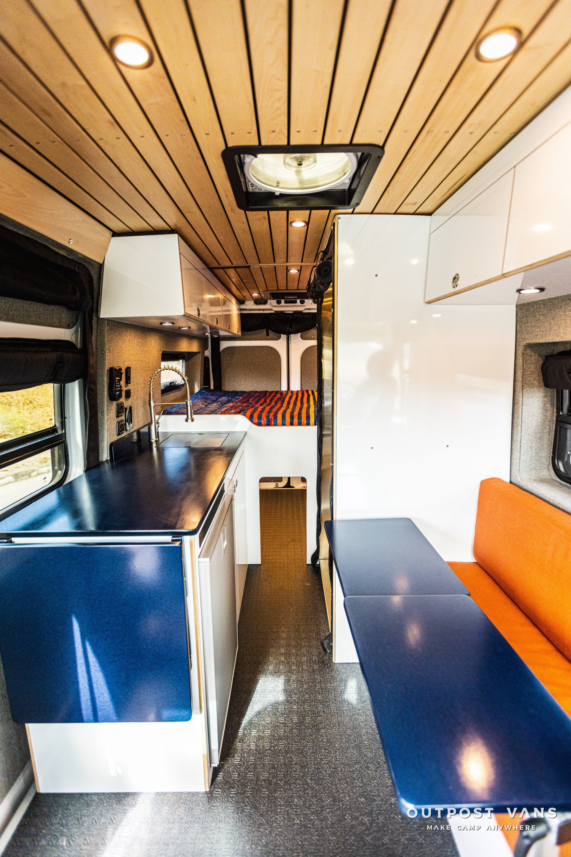 the inside of a camper van with a kitchen and dining area .