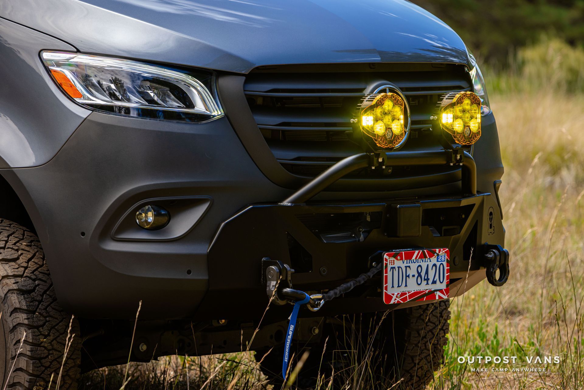 A close up of the front of a mercedes benz sprinter. Outpost vans Sprinter 170 AWD.