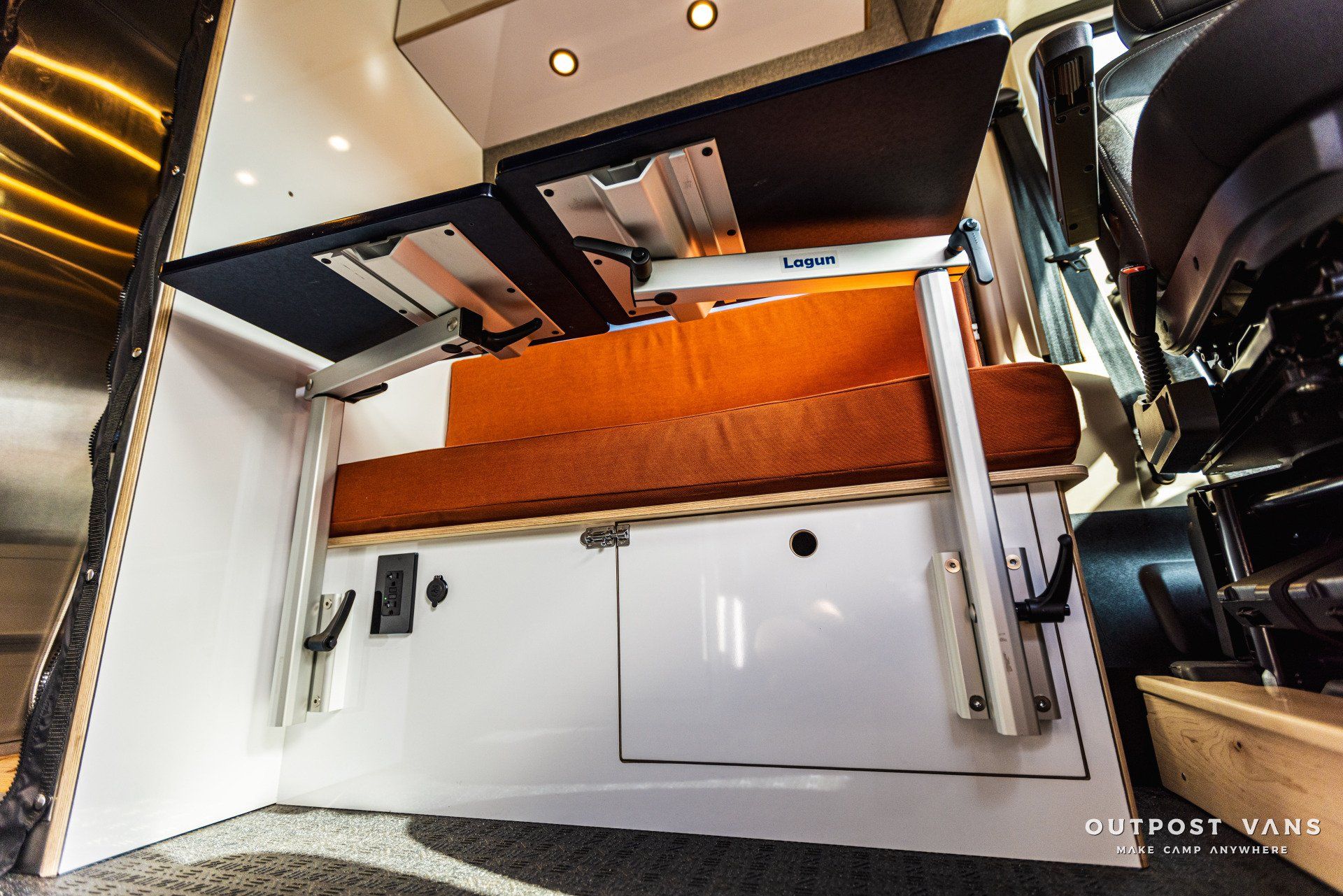 a van with a bed and a table in it