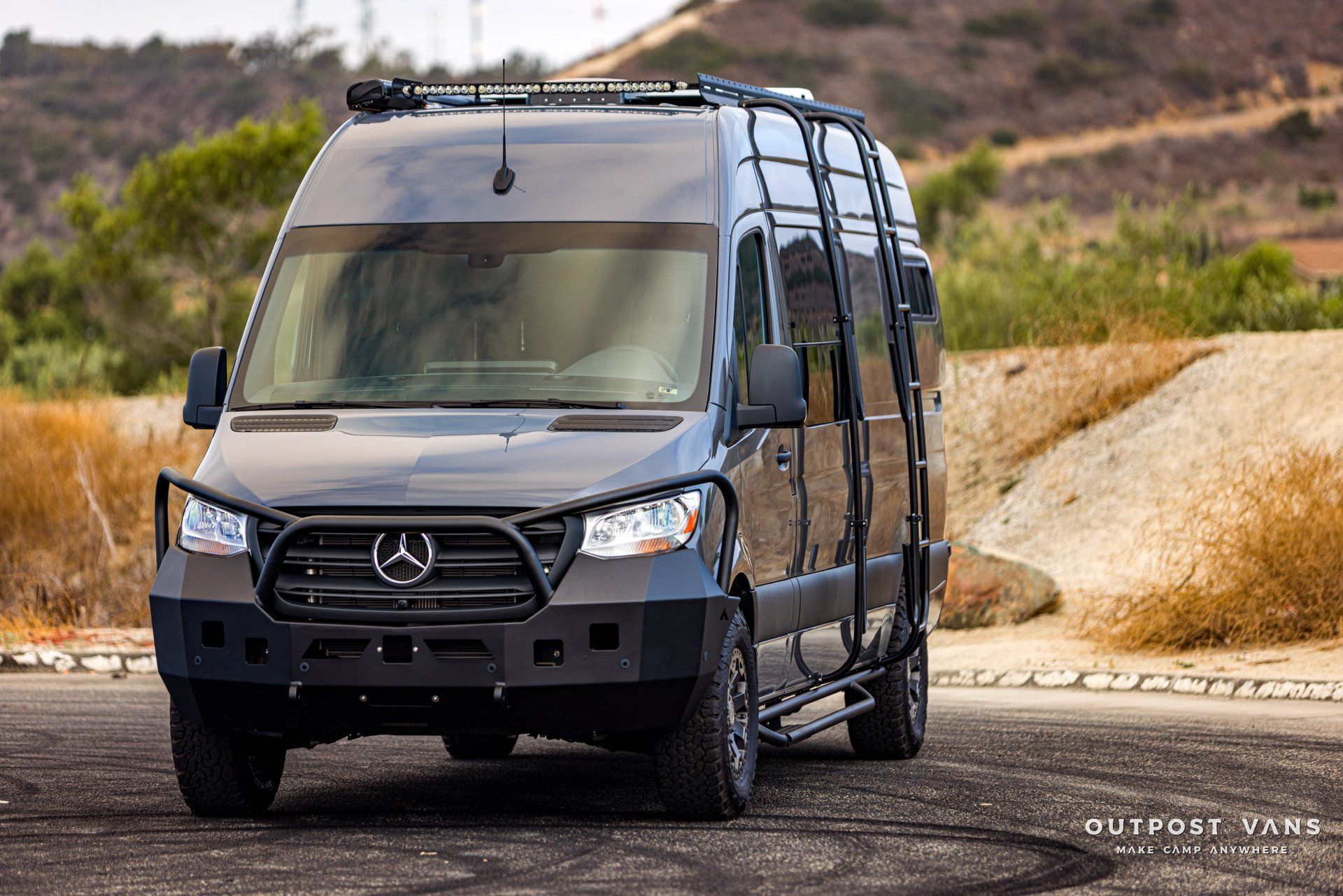 A mercedes sprinter van is parked on the side of the road.