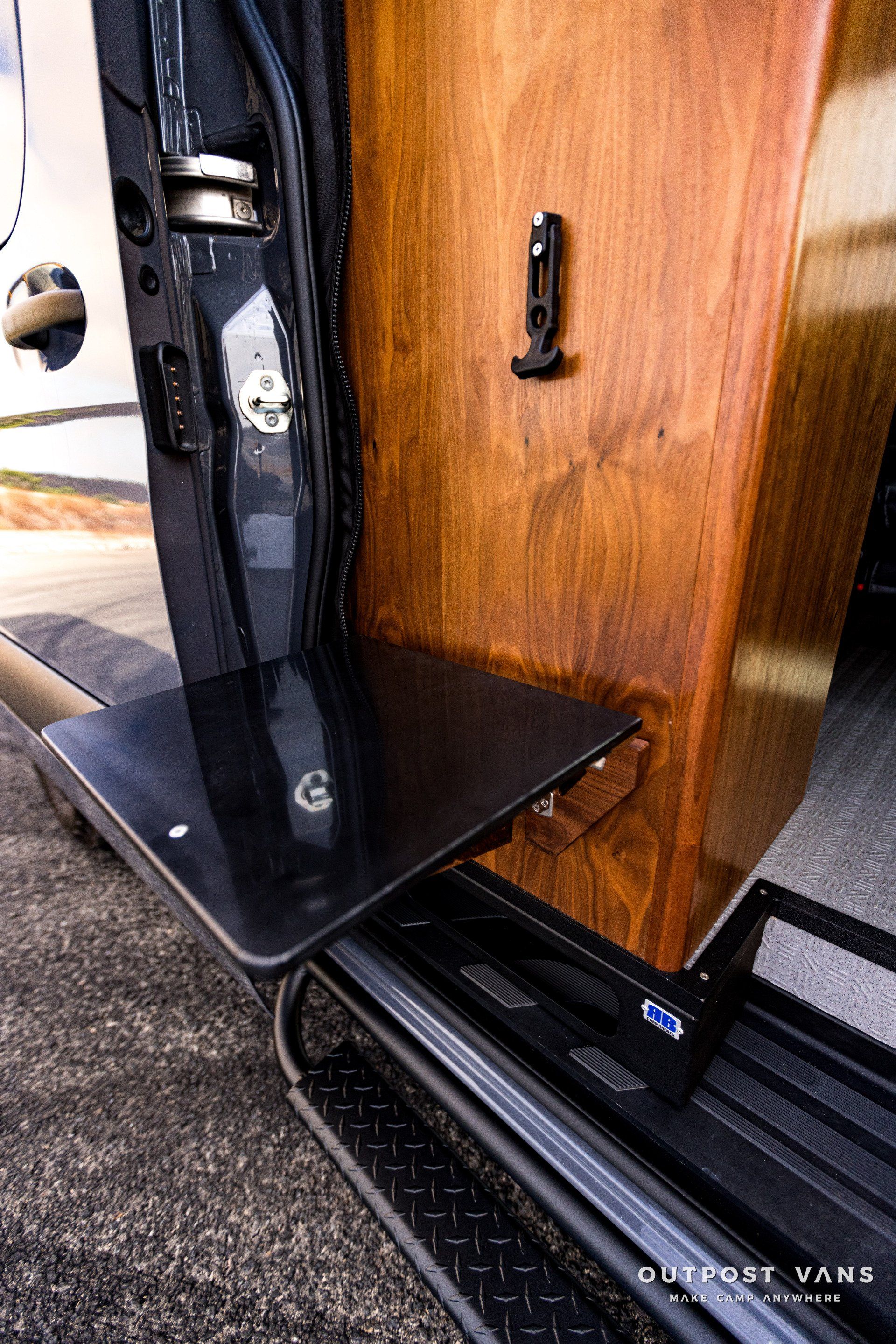A wooden box is sitting in the back of a van.